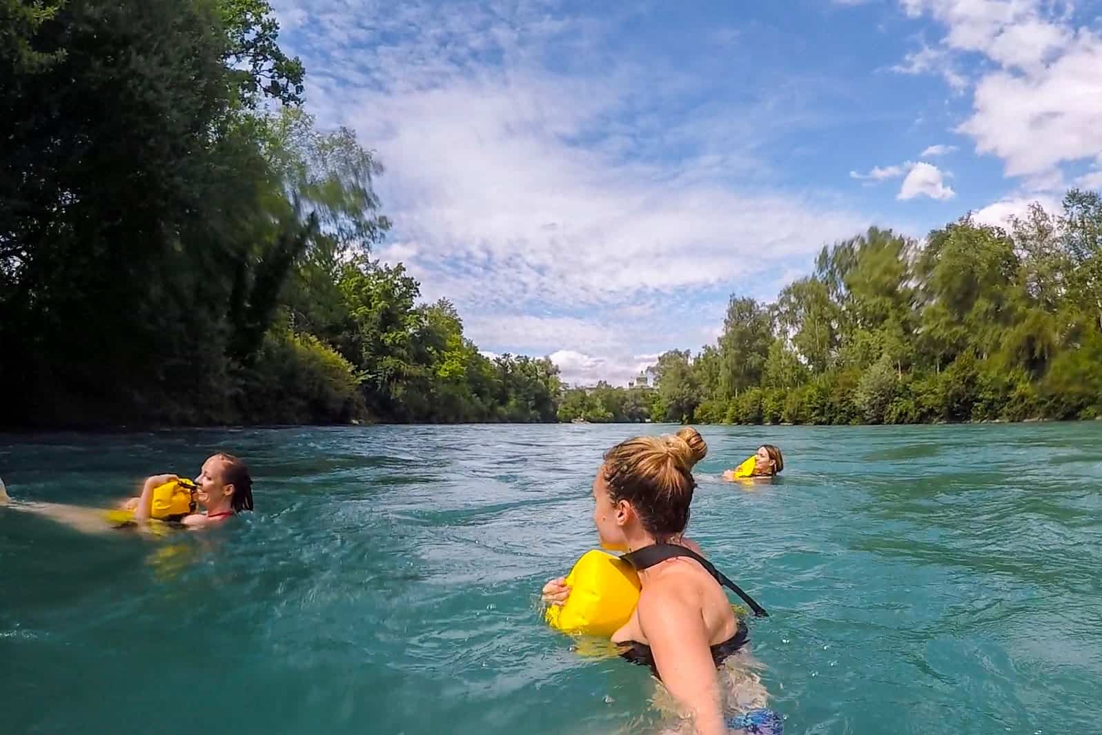 Three women enjoying the UNESCO listed Swiss tradition of swimming in the River Aare in Bern