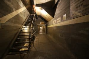 A staircase leading to a dark basement area as part of underground Berlin used during war time.