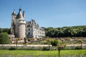 Visitors in the gardens of the silver castle-like Château de Chenonceau in the Loire Valley, France.