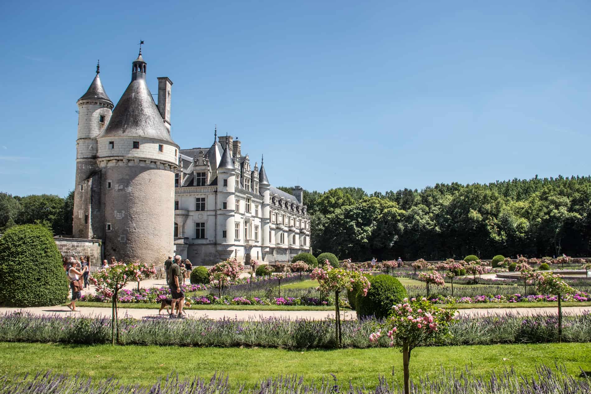 Visitors in the gardens of the silver castle-like Château de Chenonceau in the Loire Valley, France.