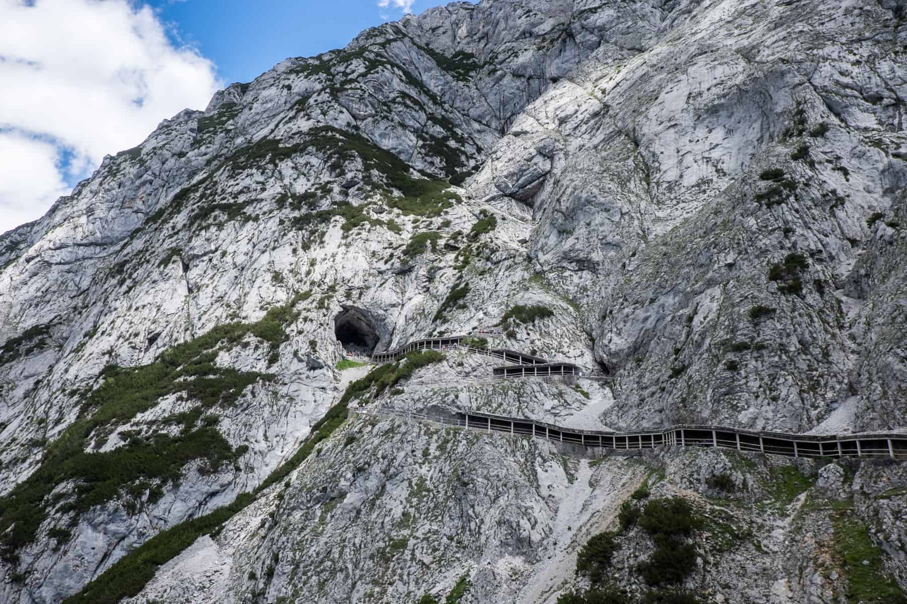 A long, steep snaking pathway leads up the moss covered limestone mountain of the Eisriesenwelt cave in Austria