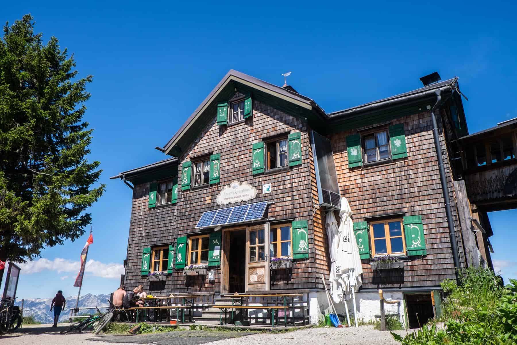 The dark wooden, green window shuttered Heinrich-Kiener-Haus mountain hut on the Hochgründeck Mountain in Austria