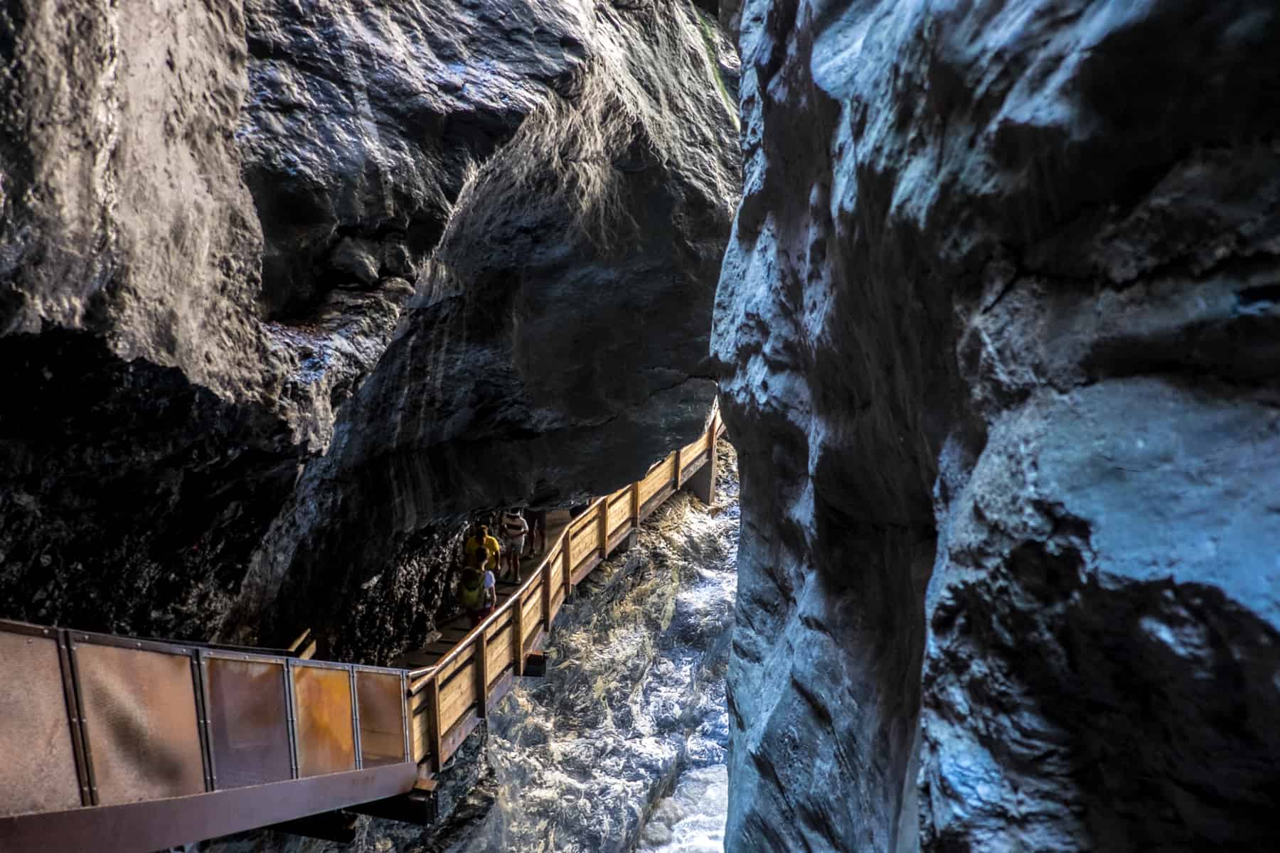 A steel and wooden walkway leads through the silver and blue toned gorge walls in Liechtensteinklamm in St Johann im Pongau Austria