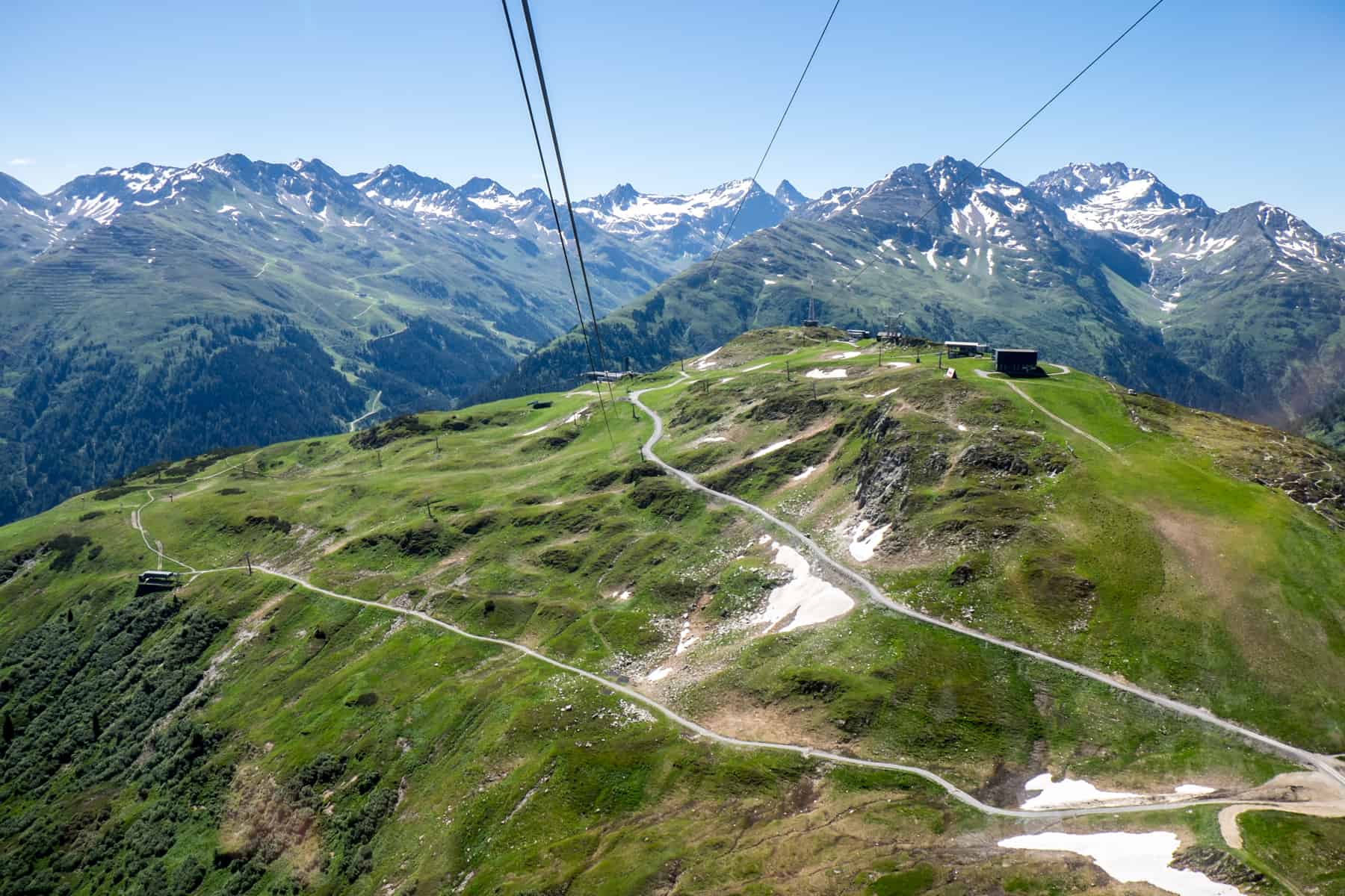 A series of hiking trails winds around a green mountain peak - the Mutspuren Circular Hiking Trail in St. Anton