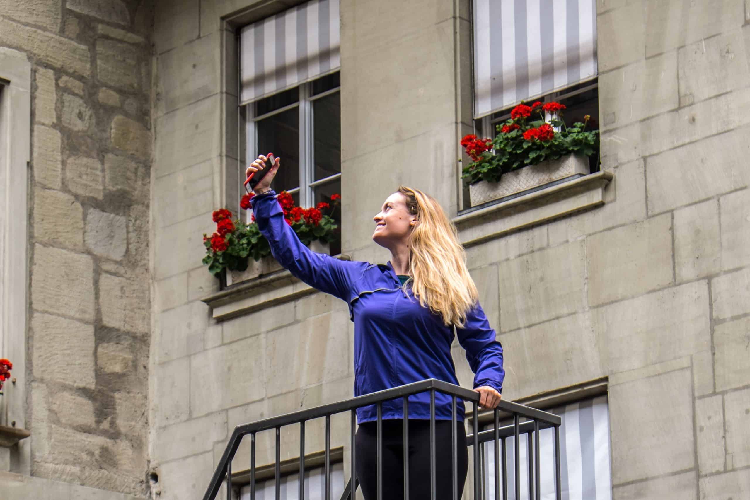 A woman wearing purple taking a selfie at the top of a viewing tower in Bern, Switzerland