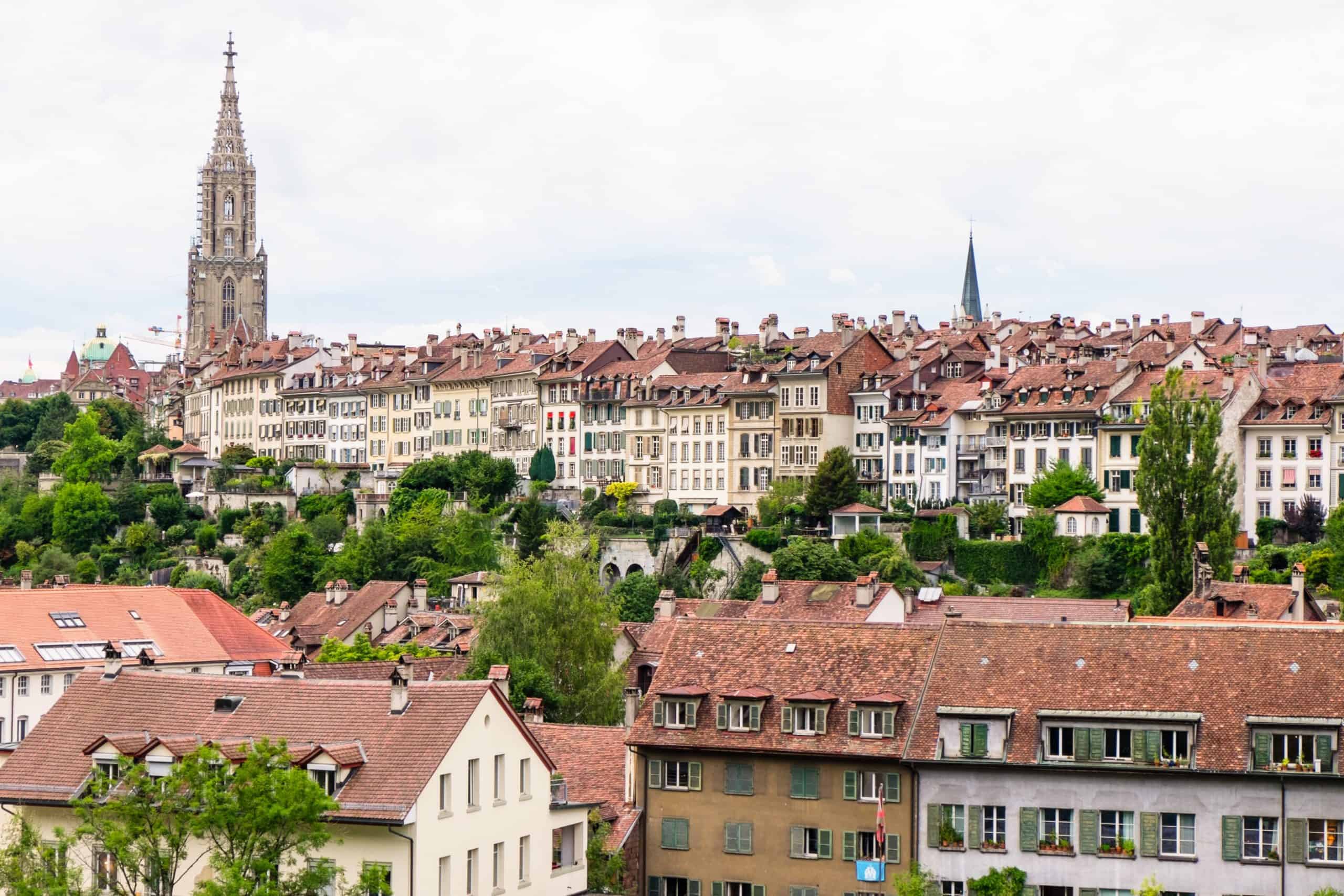 The famous red rooftops of the old city of Bern, Switzerland marked by the high church spire