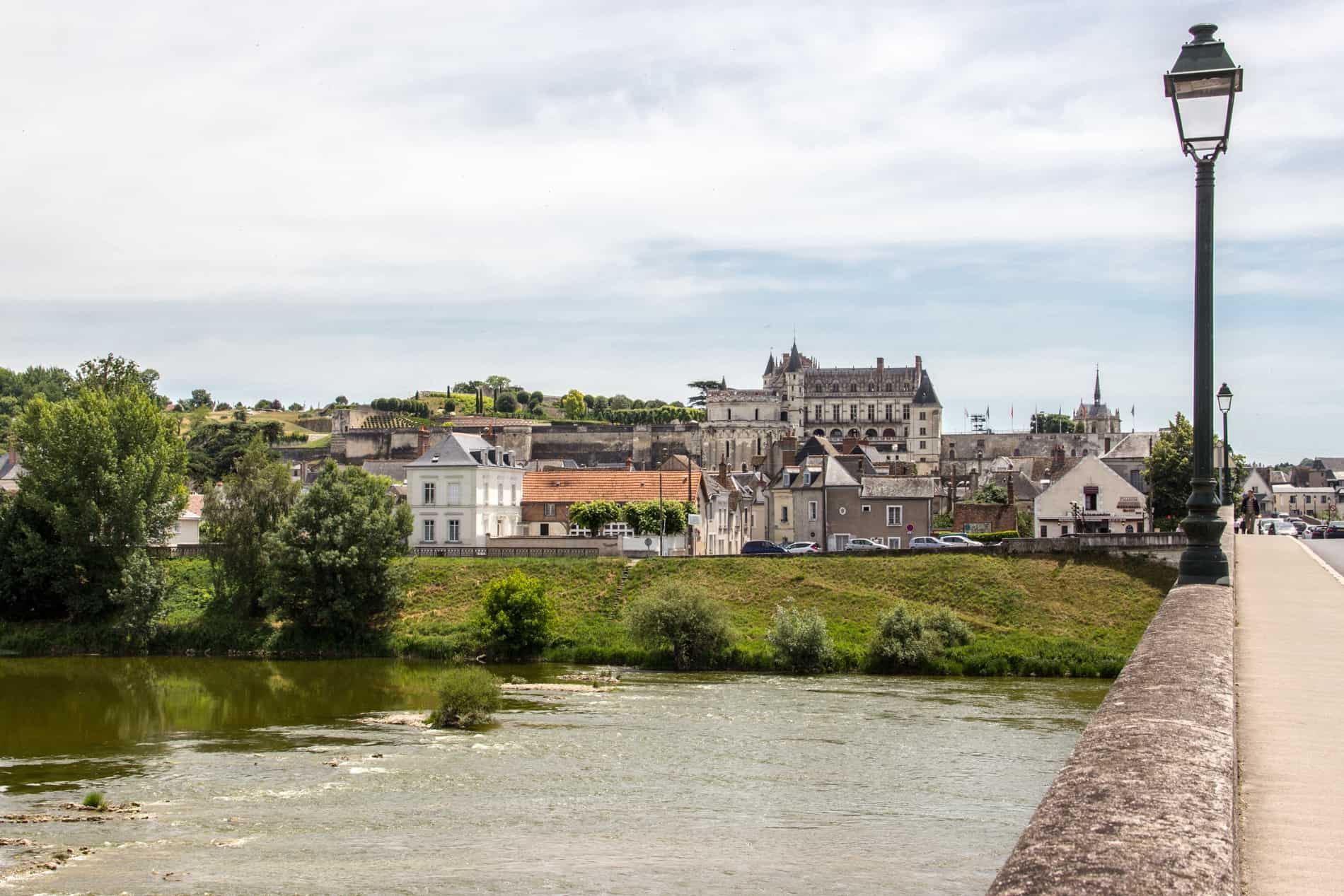 View from the bridge over the wide River Loire approaching the old town of Amboise.