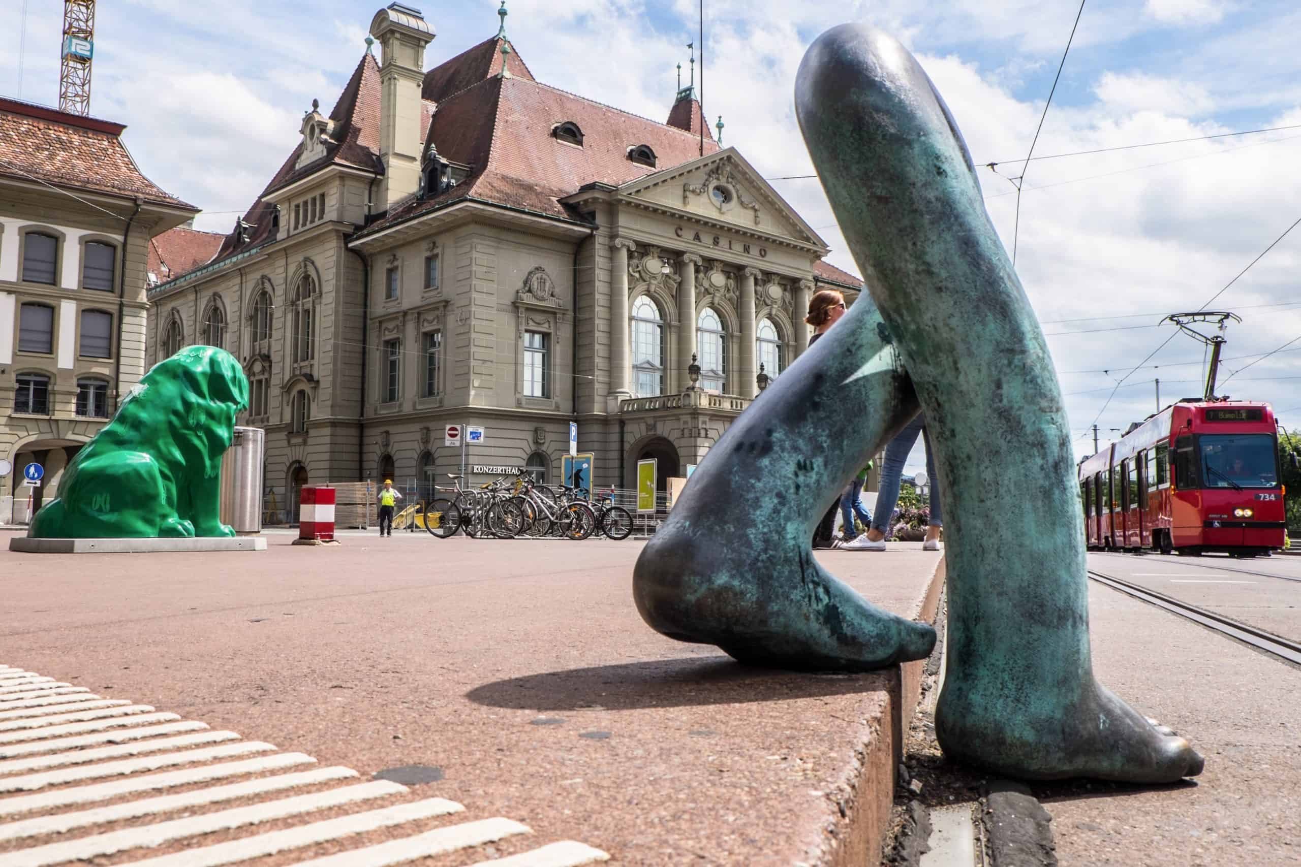 A giant green dog and giant walking legs - artistic street sculptures in Bern, Switzerland