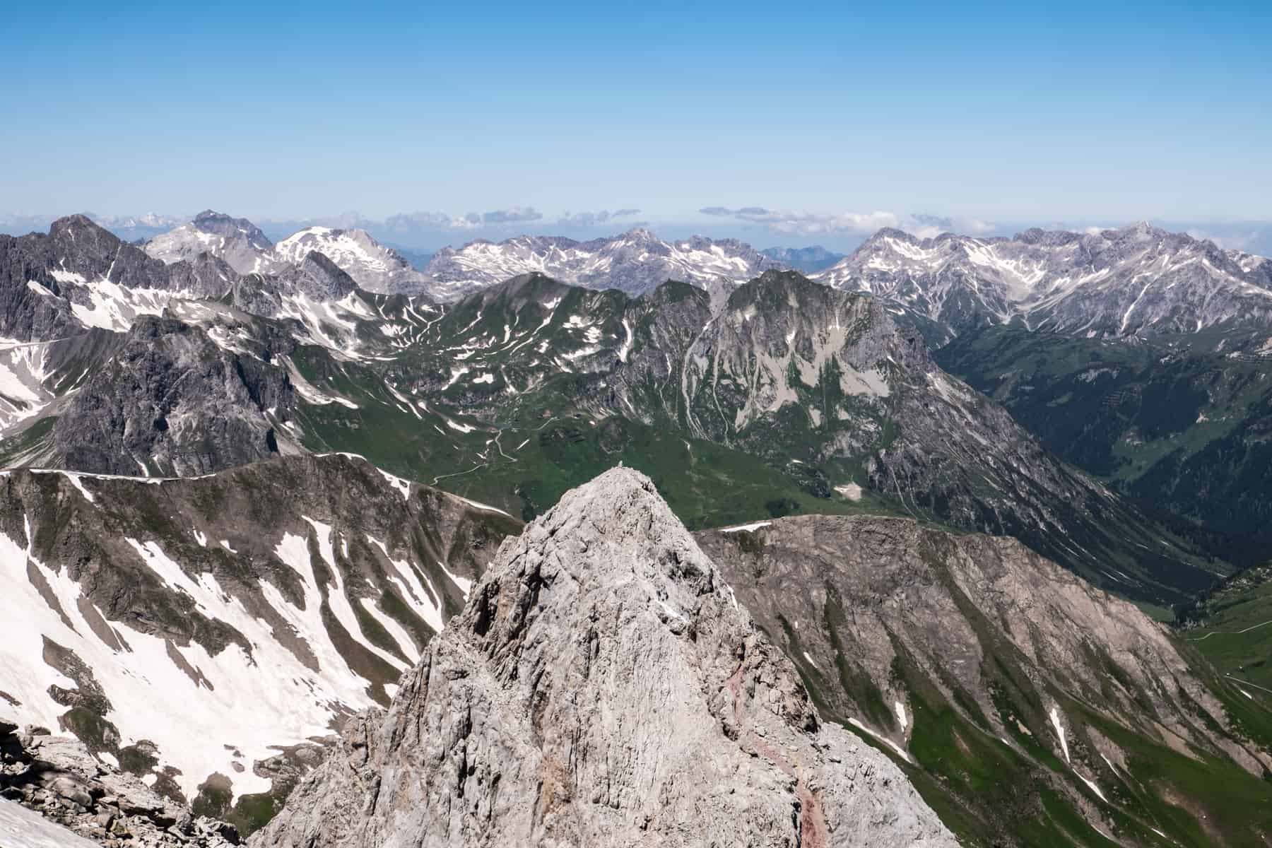 Layers of mountains peaks and rocky formations as seen from the Valluga mountain viewing platform in St Anton Tirol