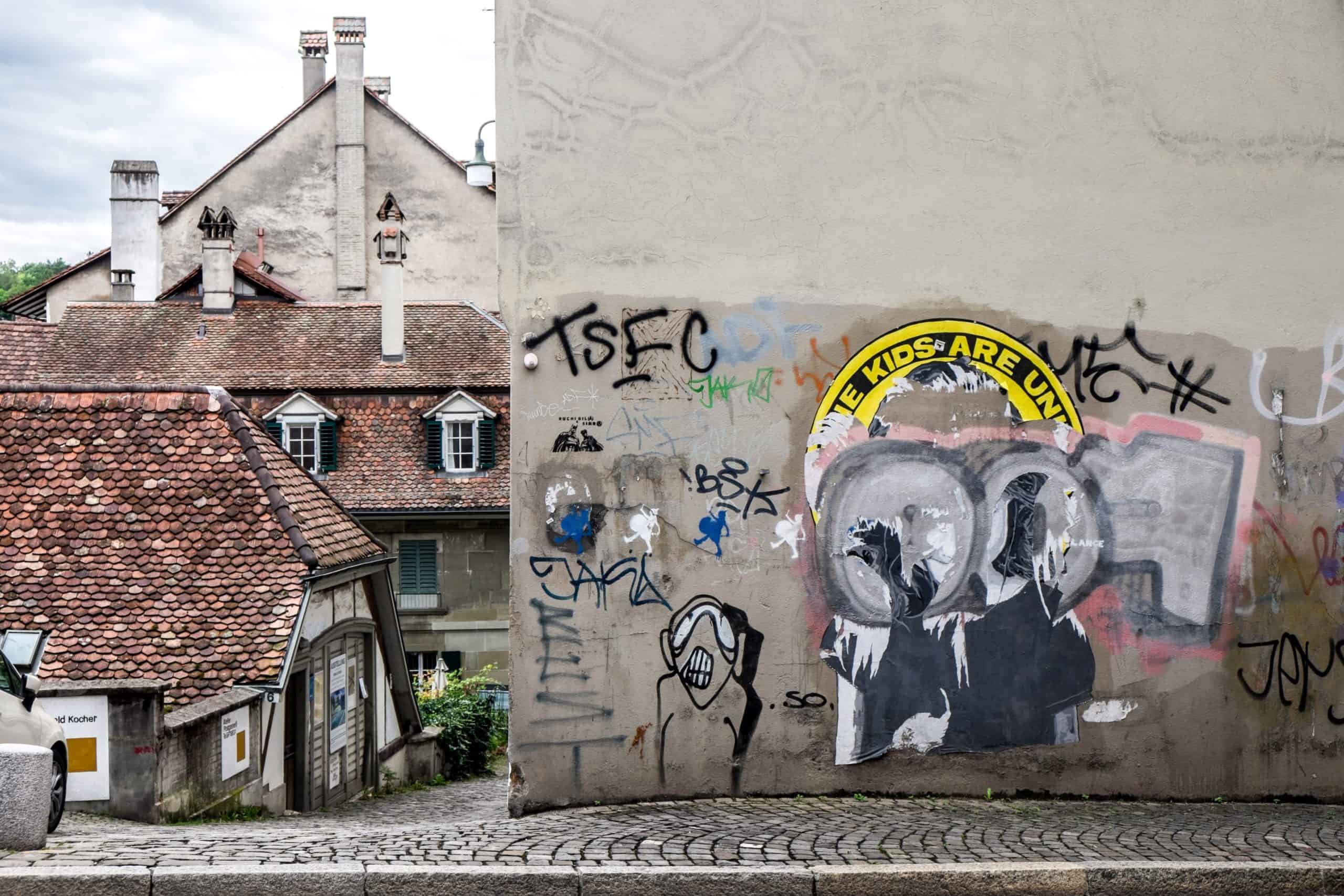 Street art in old Bern city, Switzerland, a modern image next to timeless red-roofed houses