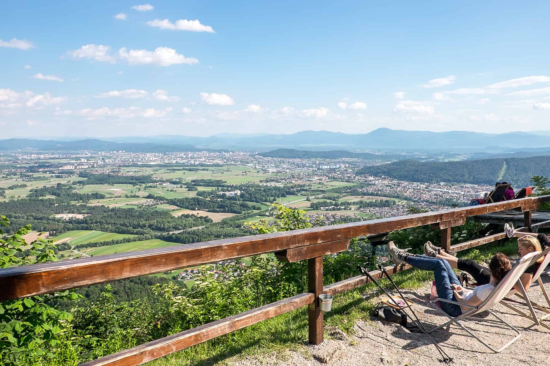 People resting after trekking up to the lookout point of Smarna Gora Mountain near Ljubljana.