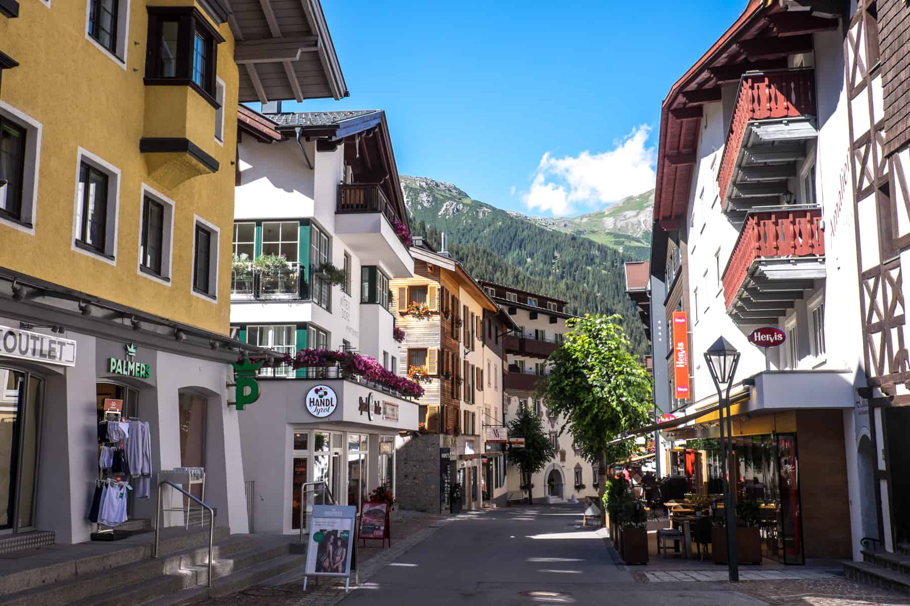 A main street full of shops and hotels in the village of St Anton Tirol Austria