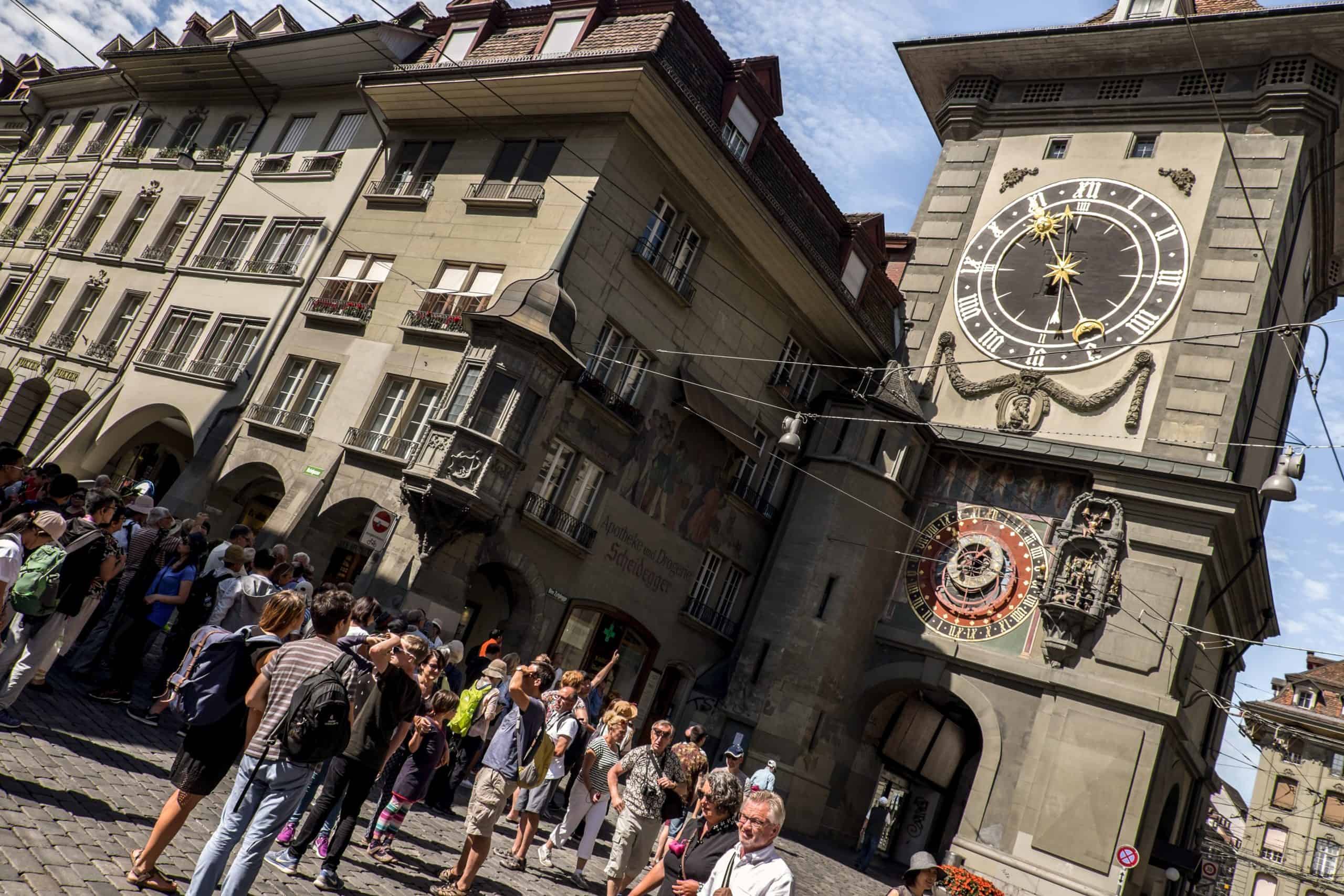 A small group of tourists outside the Zytglogge Clock Tower in Bern, Switzerland