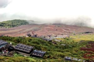 View of the zigzag hiking trails through red volcanic soil, climbing Mt. Fuji in Japan.