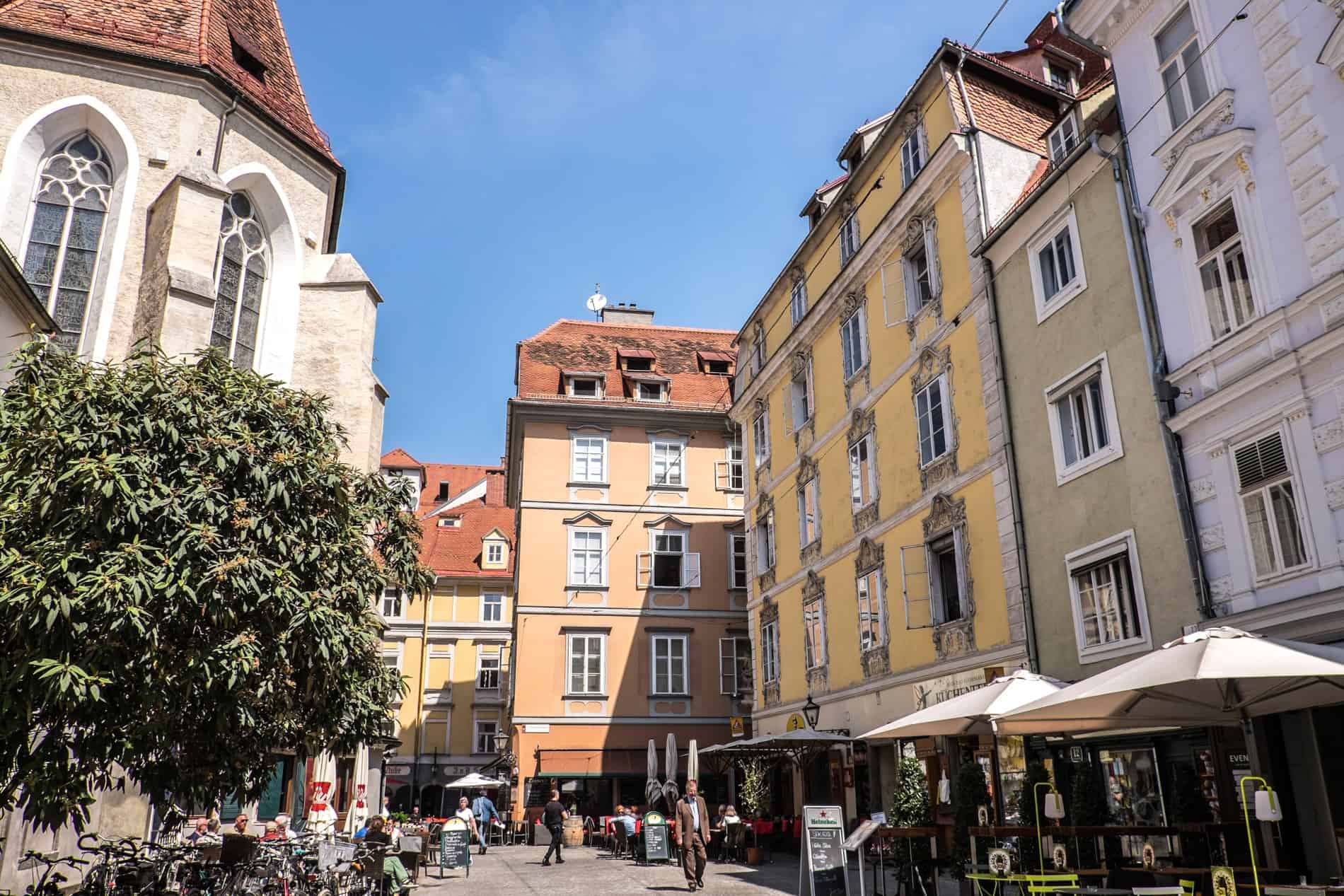 Yellow-hued, Mediterranean style buildings and open squares in the old centre of Graz, Austria. 