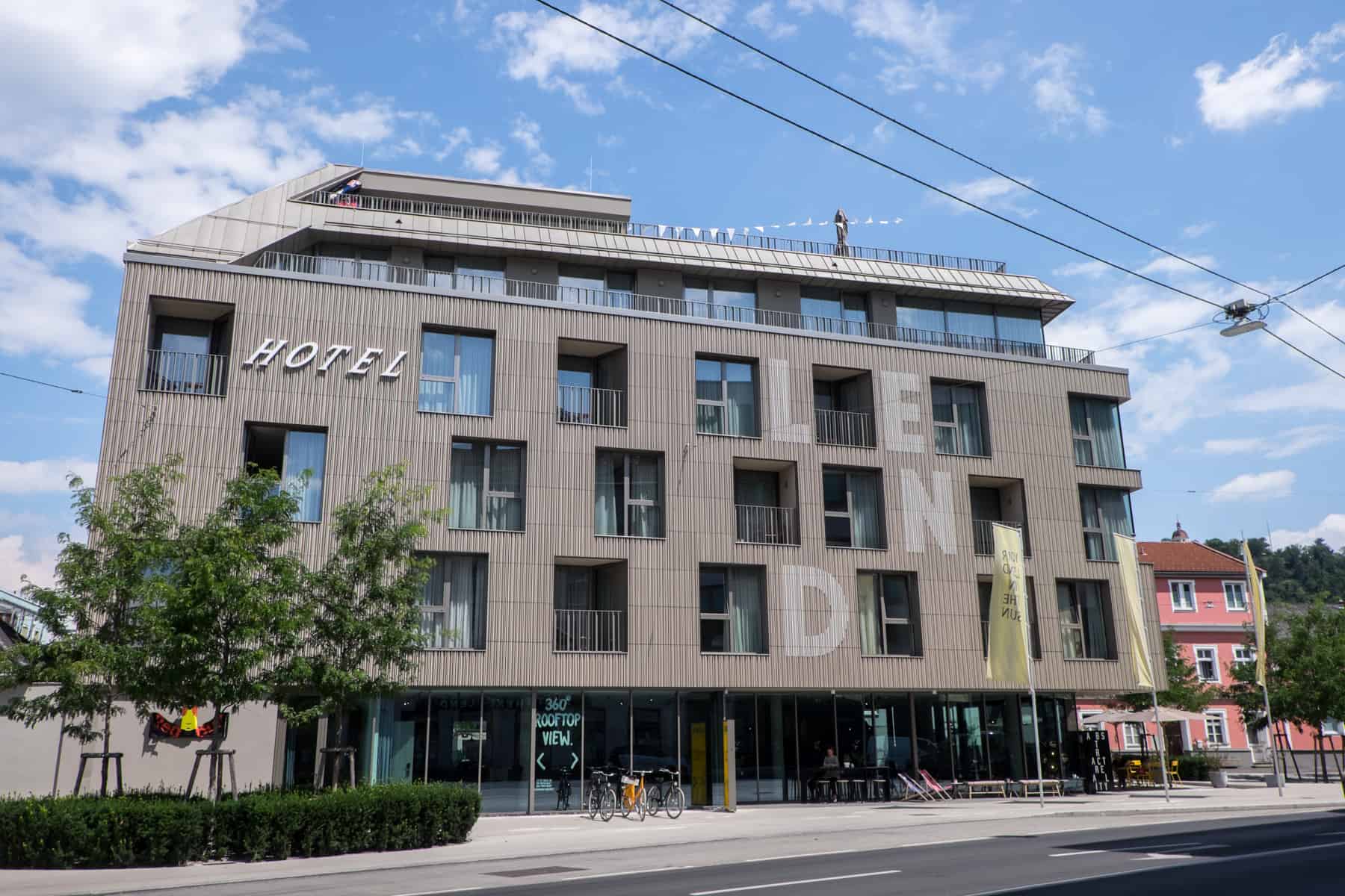 The minimalist brown exterior and huge windows of the Lend hotel in Graz, Austria