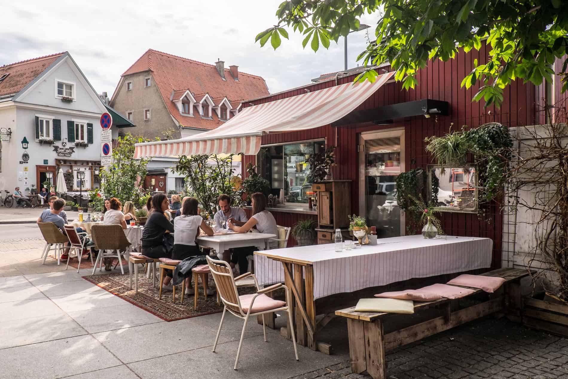 People eating outside at a restaurant in the Lend neighbourhood in Graz.
