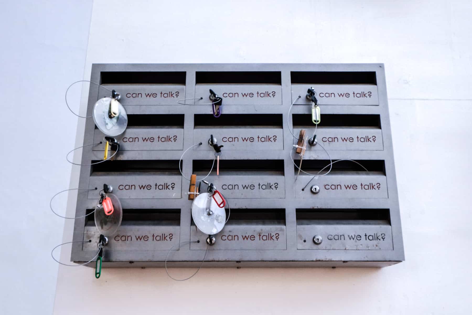 A box with 12 key boxes and keys, each with the text "Can we talk?" - one of the modern art displays in Stellenbosch, South Africa