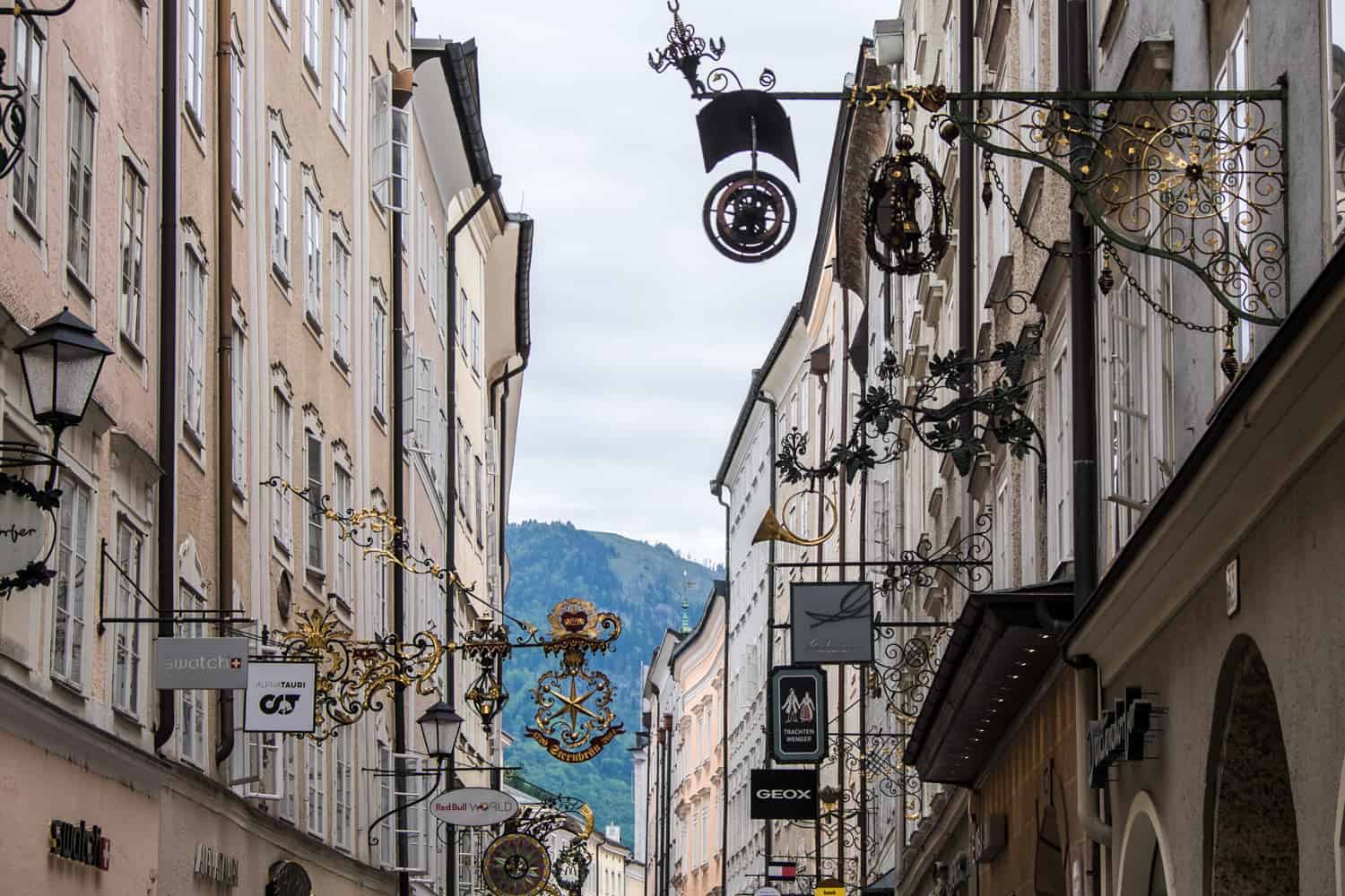 The delicate and pretty gold and metal shop signs that line the shopping street of Getreidegasse in Salzburg.