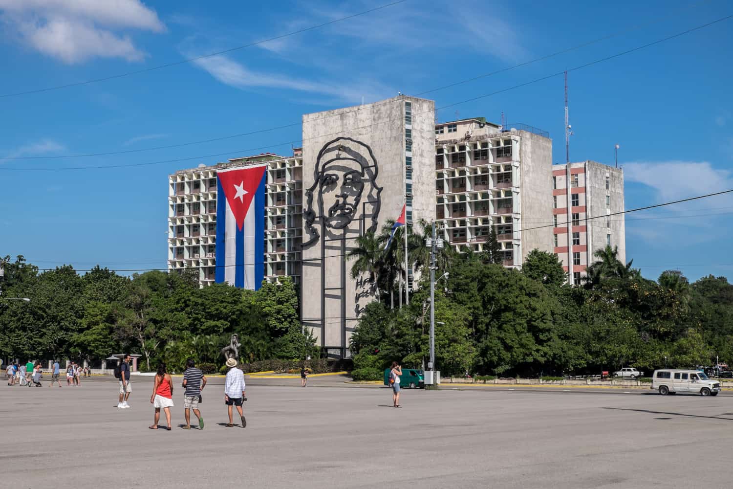 A Cuba flag and metal artwork of Che Guevara on the side of the shabby concrete Minister of the Interior building on Revolution Square, Havana. 