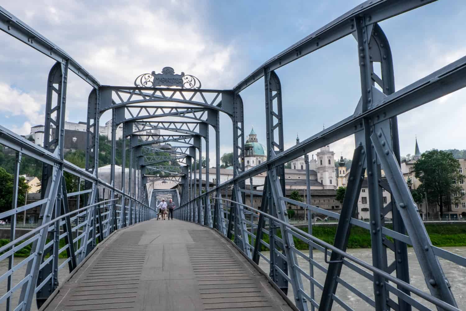 The dark metal poles, handrails and archways of a bridge in Salzburg made famous in the Sound of Music.