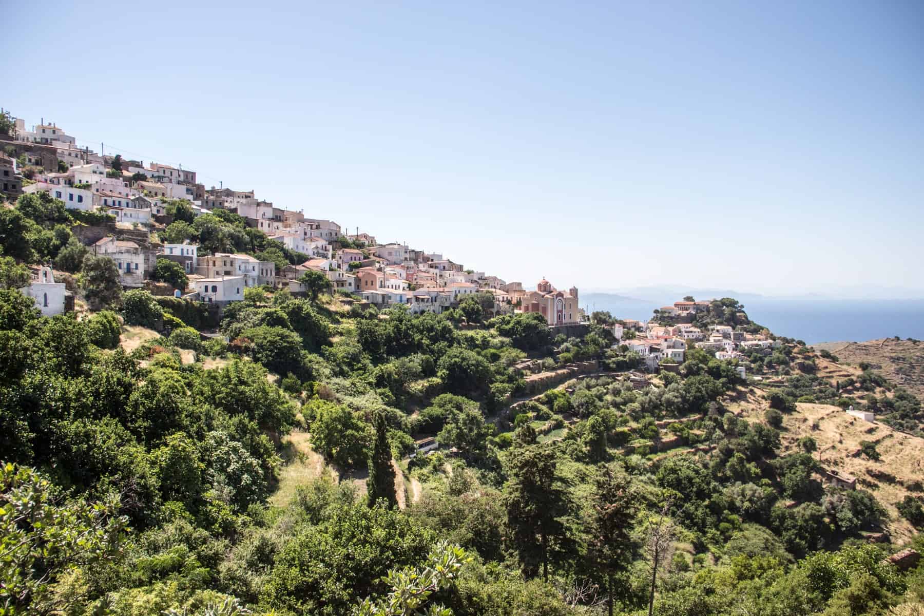 One of the village on Kea Island whose houses blend into the thick folige and wilderness of the hillside. You can see a little part of the sea in the distance.