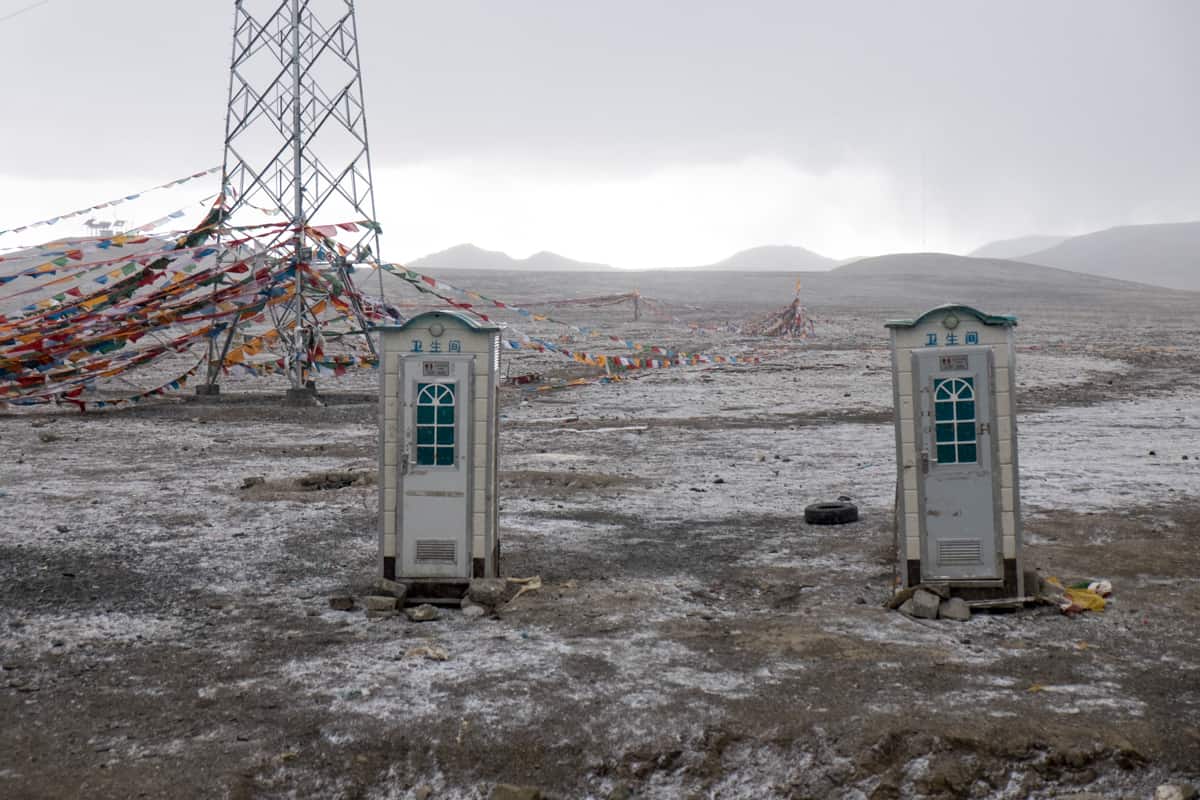 The white portable toilets at the high, flat Gyatso pass in Tibet are the highest toilets on earth