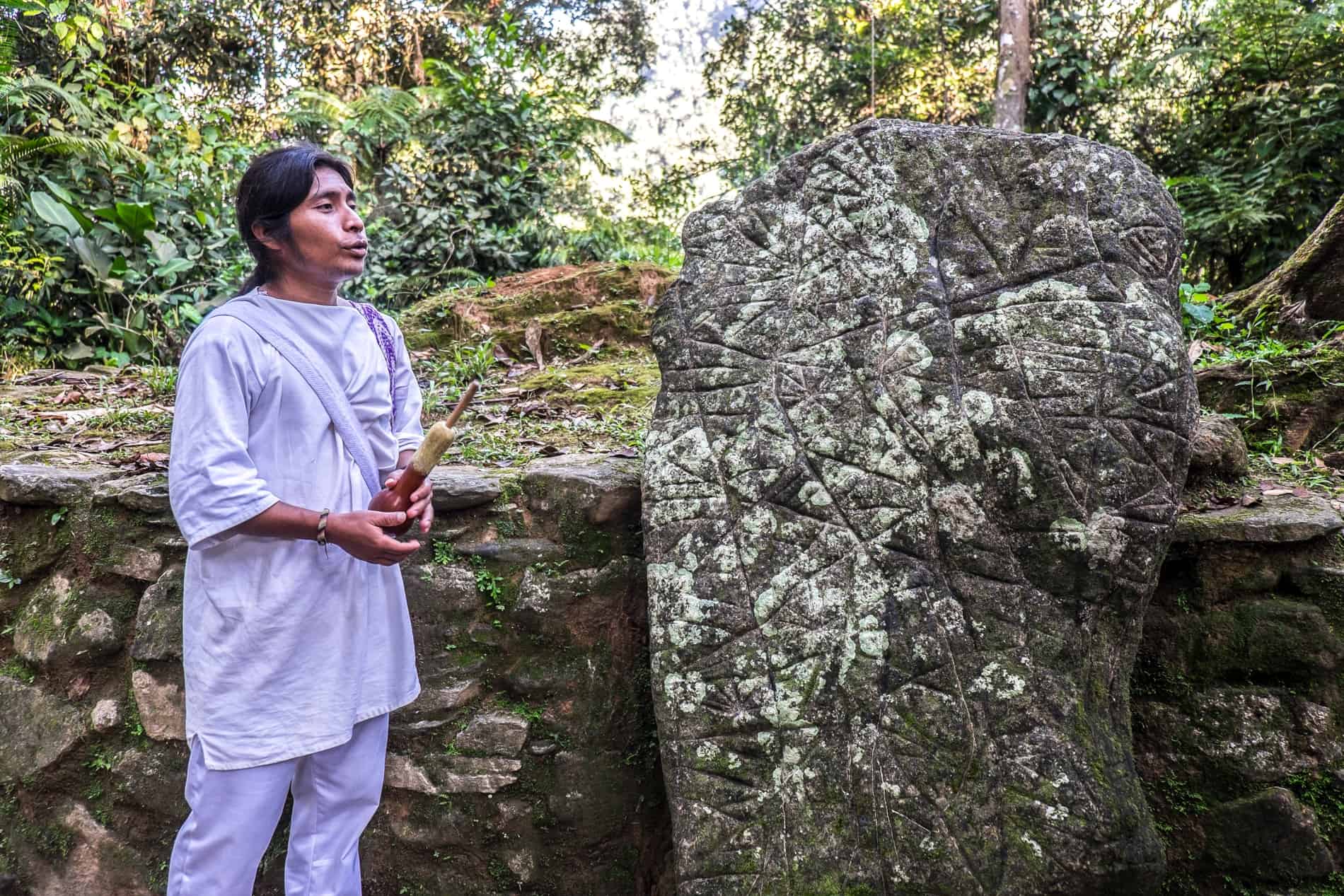 Wiwa man shows rock map in the Ciudad Perdida, Colombia.