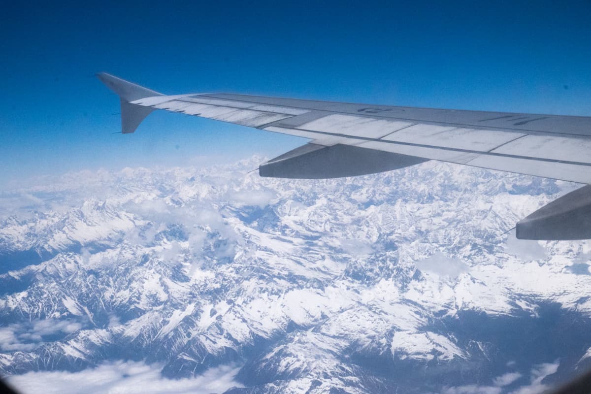 The view of the snow-capped Himalaya mountain range seen from inside the airplane from Kathmandu to Lhasa on a Tibet travel trip