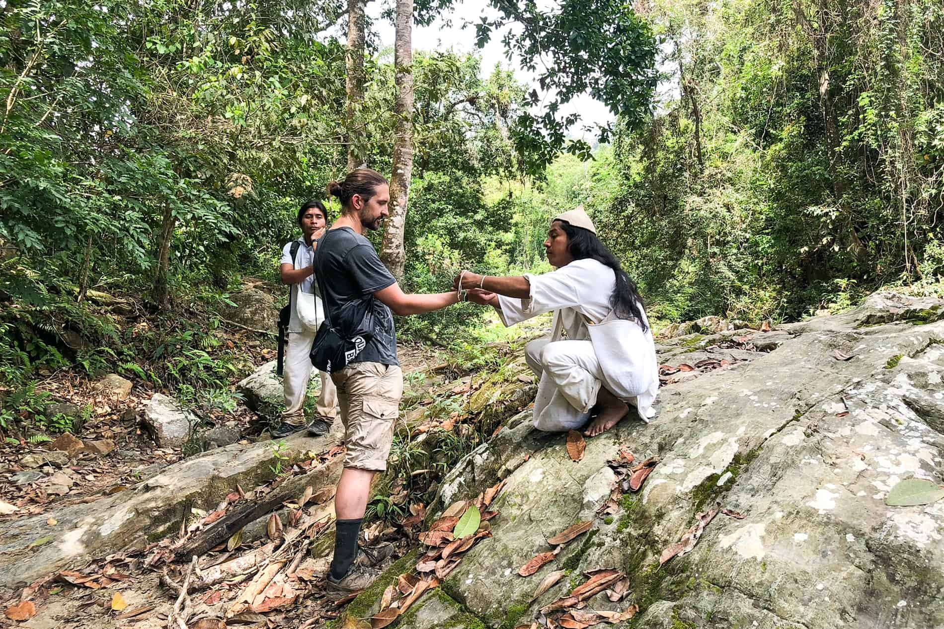 A Wiwa mamo blessing a passenger on the Lost City Trek in Colombia. 