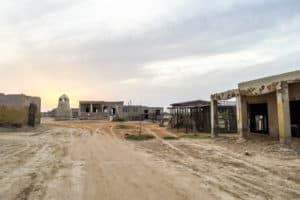 A far few of the abandoned buildings of Al Jazirat Al Hamra village in Ras Al Khaimah. A ghost city with shells of buildings left in the desert sands.