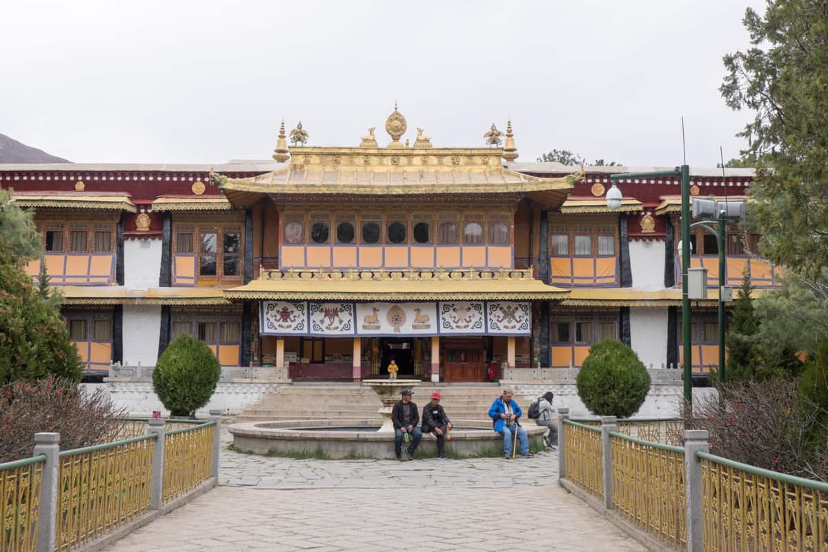The double golden roof exterior of the Norbulingka Summer Palace in Lhasa, Tibet where tourists visit as the last residence of the Dalai Lama before he fled to India