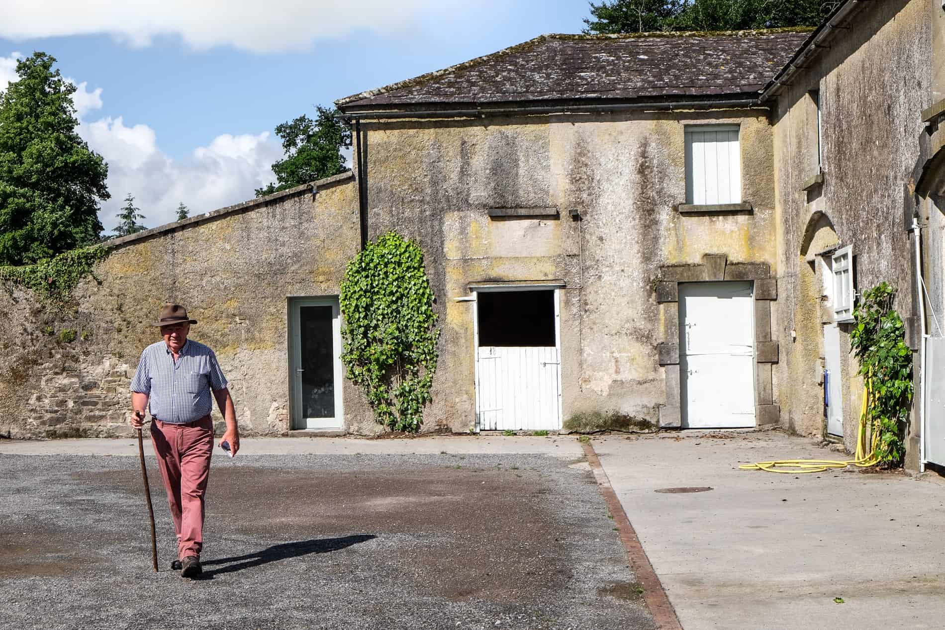 Joe O'Connor walking outside the farm house at Jerpoint Park, the site of a lost ancient city in Ireland. 