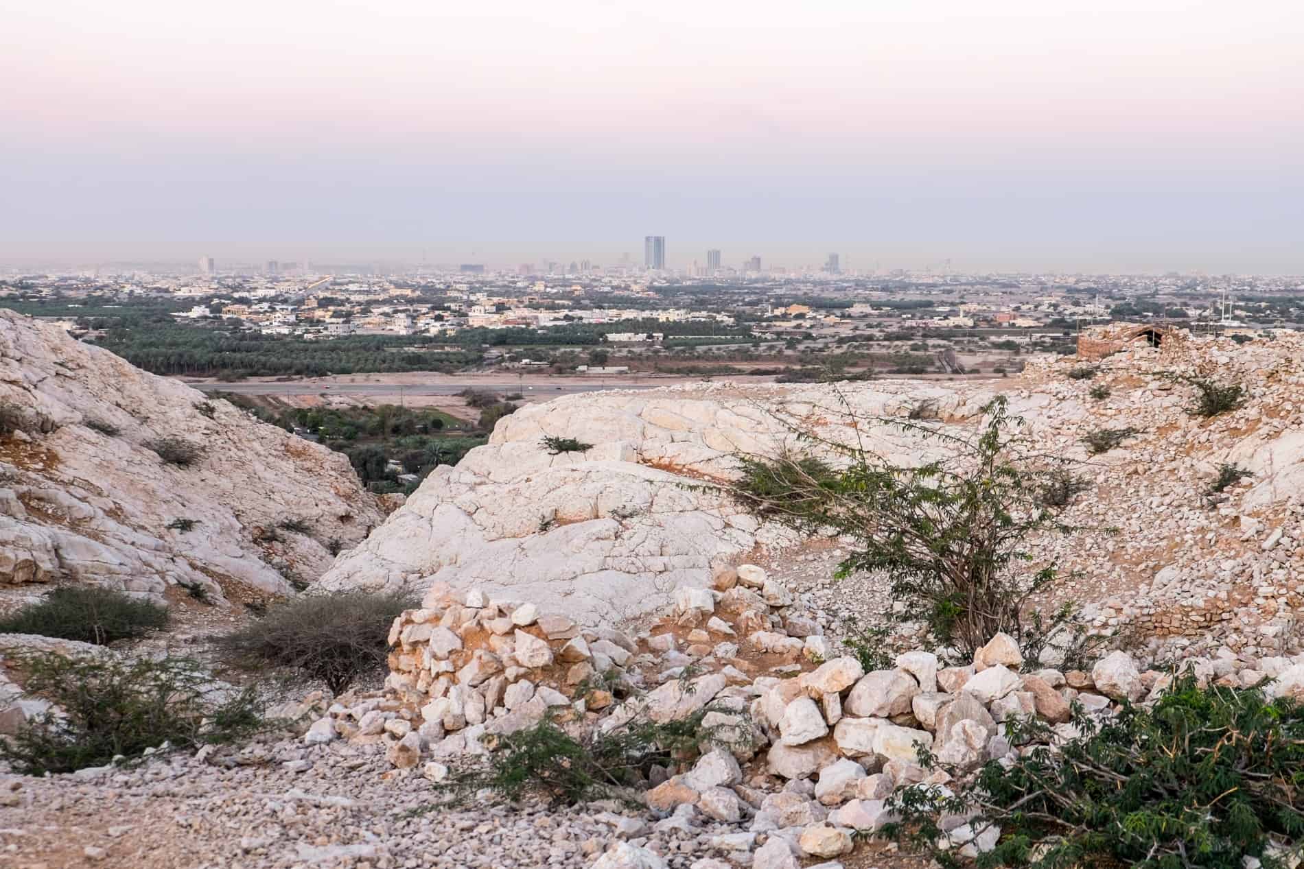 Views to Ras Al Khaimah city from atop a rocky mound in the Jebel Jais mountains. 