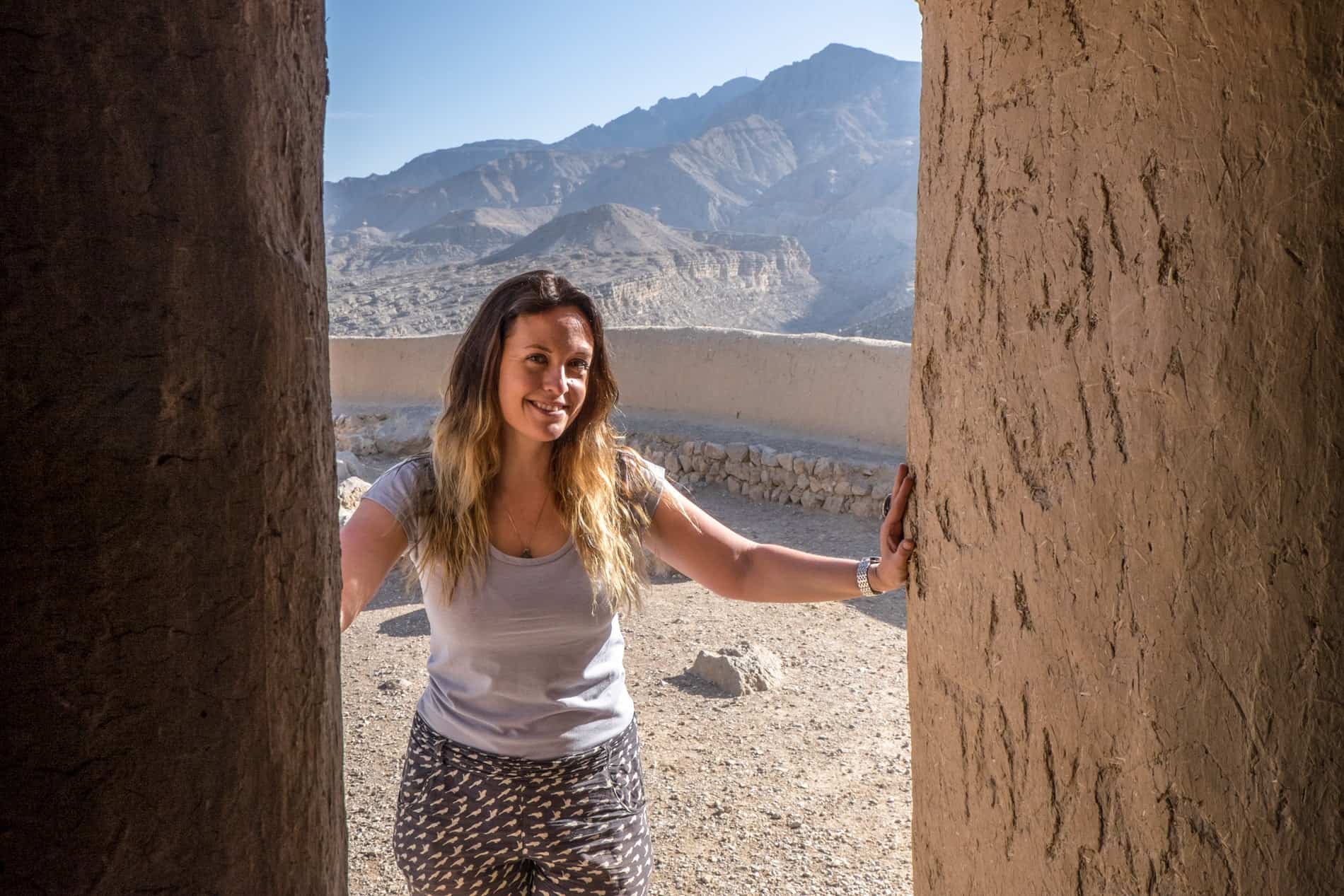 A woman stands in the doorway of a mud-brick fortress in Ras Al Khaimah. 