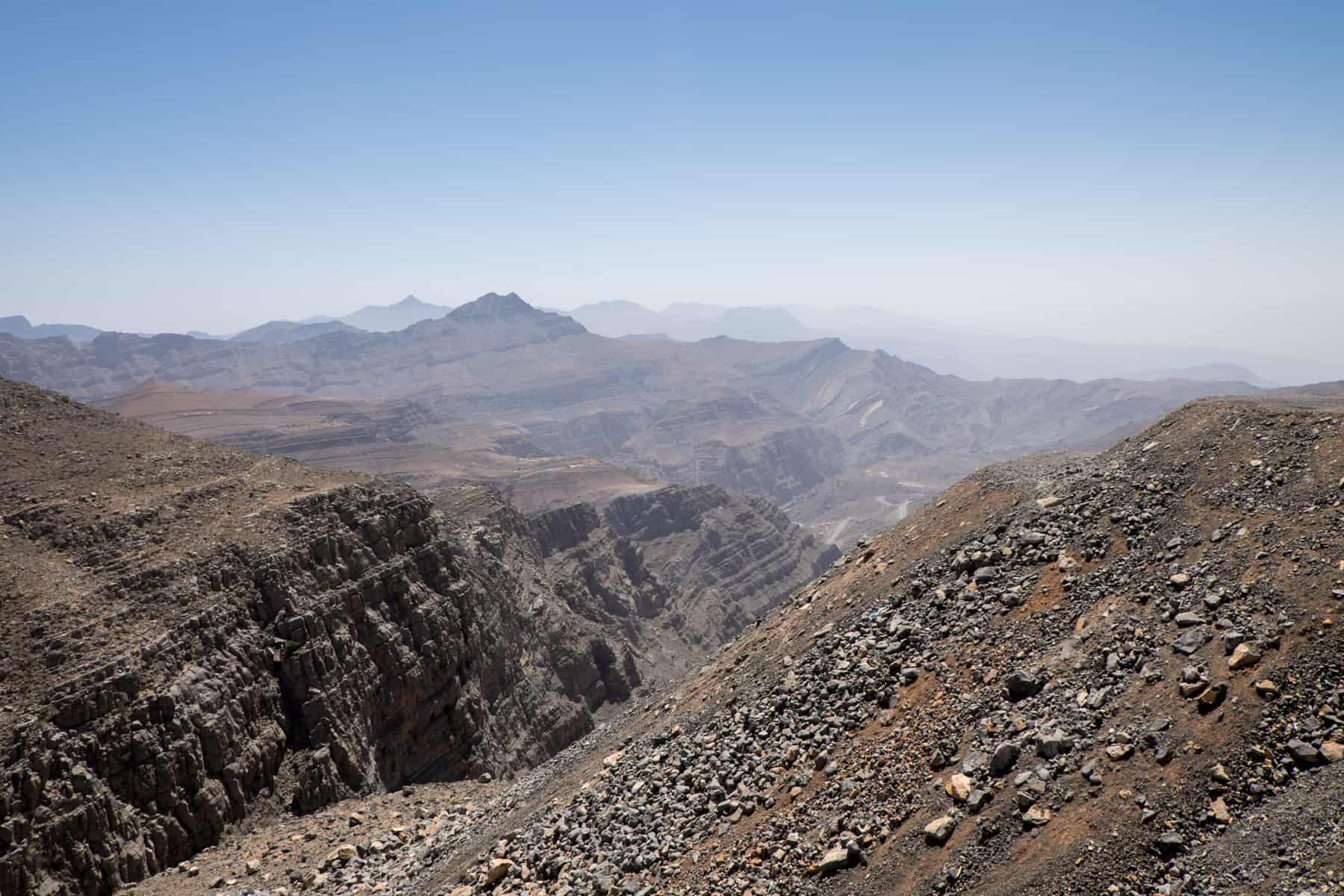View of the dark, rocky, Jebel Jais mountain range in Ras Al Khaimah - the highest mountain in the UAE.