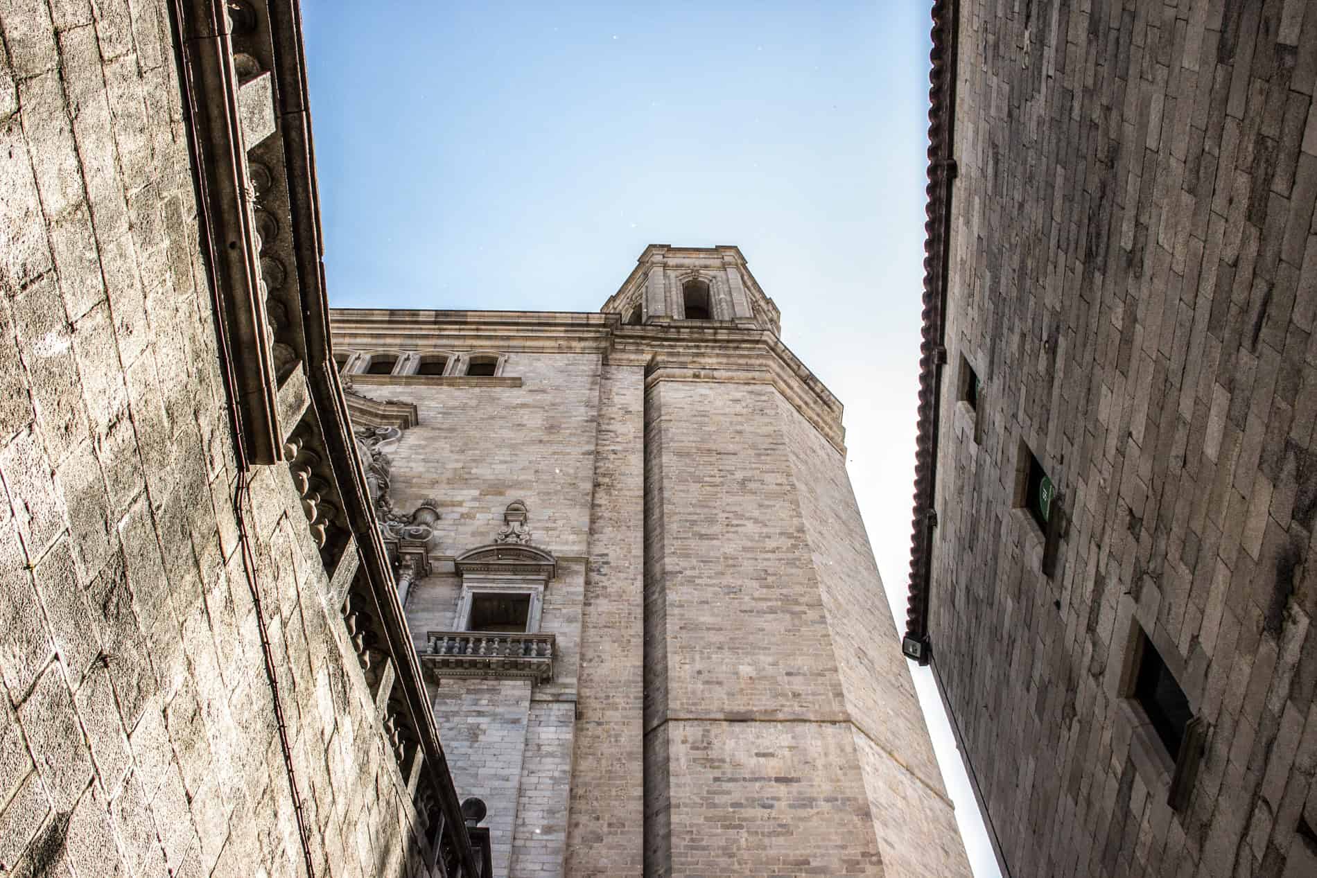 A view looking up to the high stone walls and ramparts of the Roman Força Vella Fortress in Girona, Spain. 
