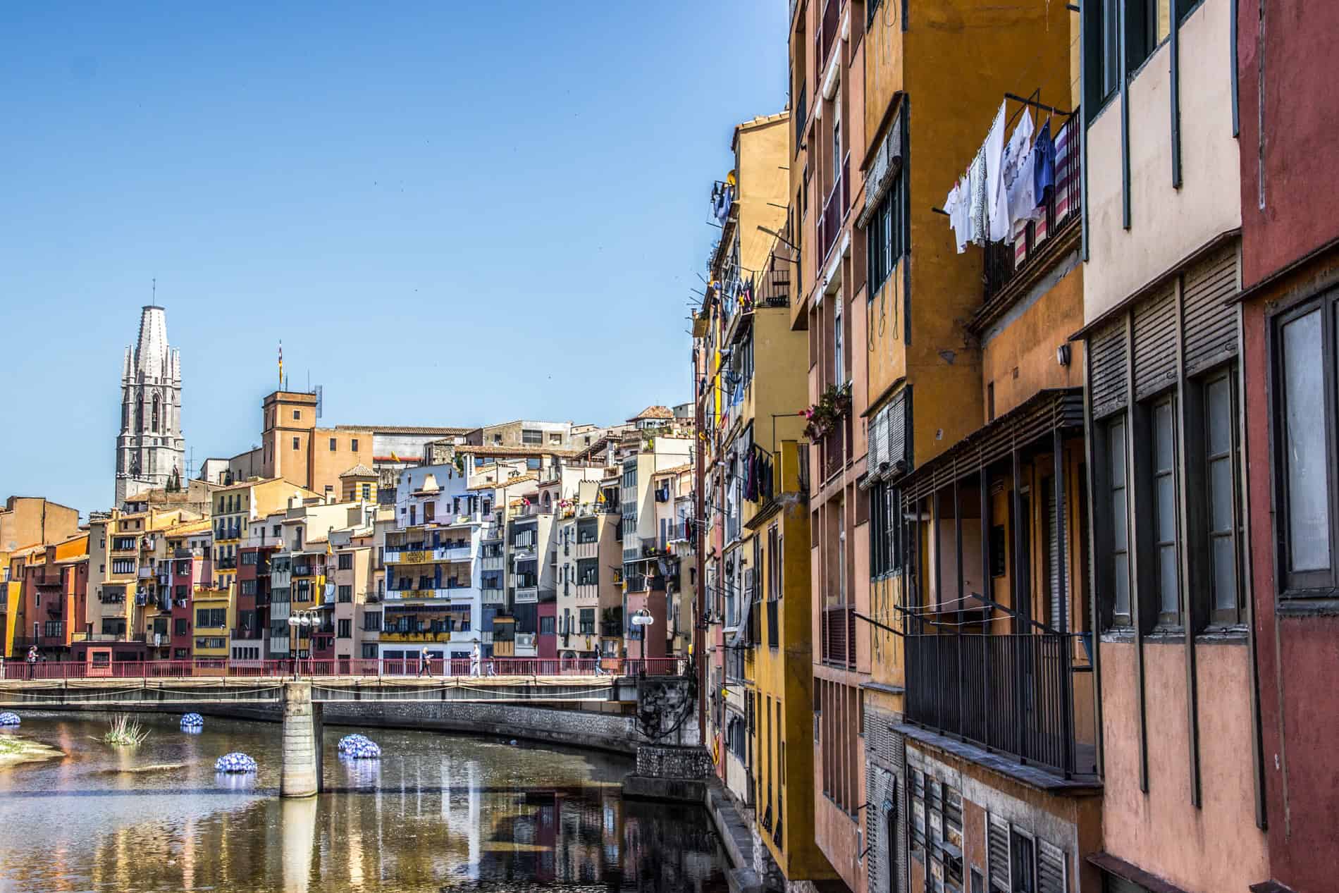 A stretch of modern multicolour buildings in Girona on the River Onyar. 