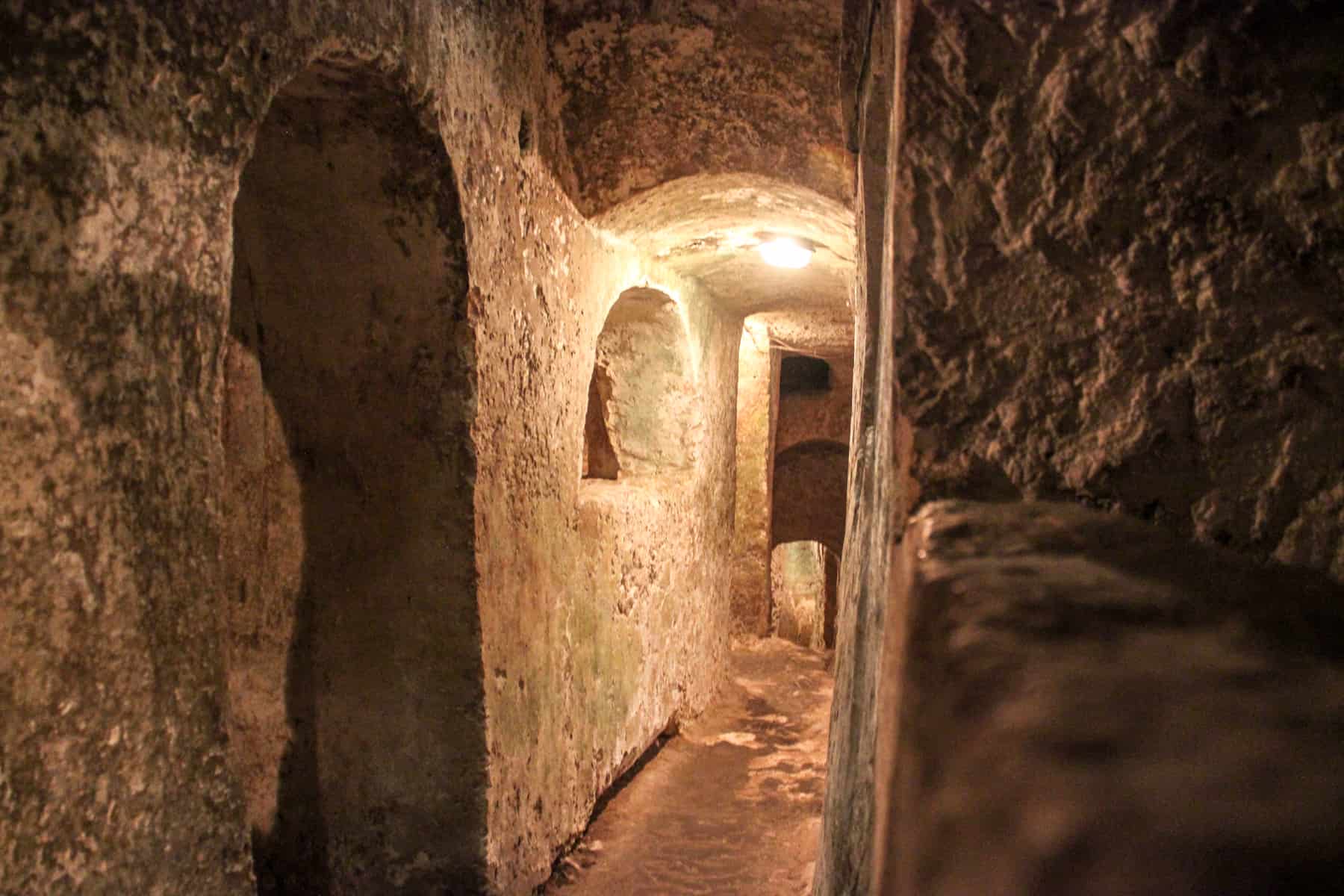 The narrow stone underground tunnels of the Catacombs of St Paul in Malta.