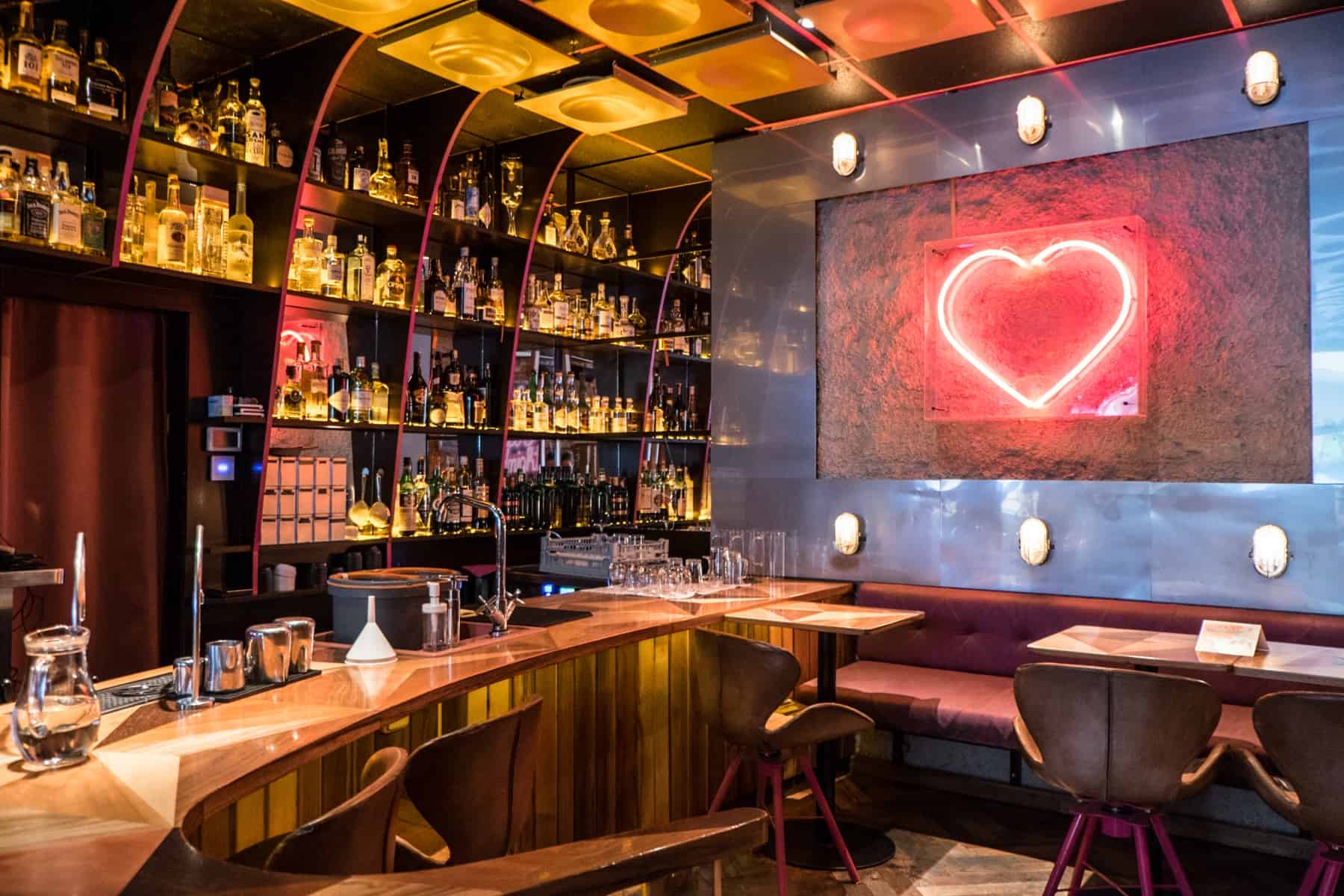 The retro, wooden decor, golden lit and red neon heart light bar at 4pokoje bistro in Brno, Czech Republic. 