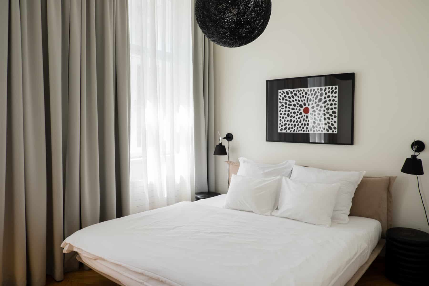 A modern decorated bedroom with black and white furnishings. 