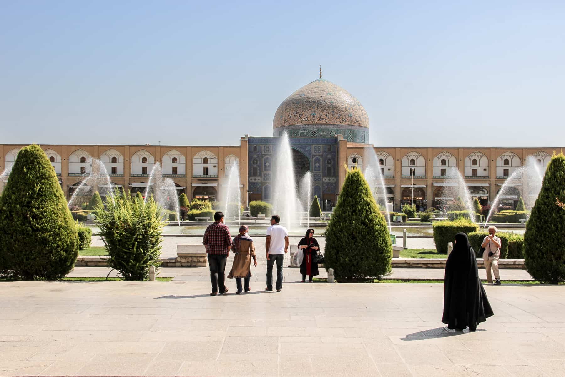Visitors walking in the garden grounds in front of The Great Mosque Masjid-e Jameh of Isfahan on an Iran trip.