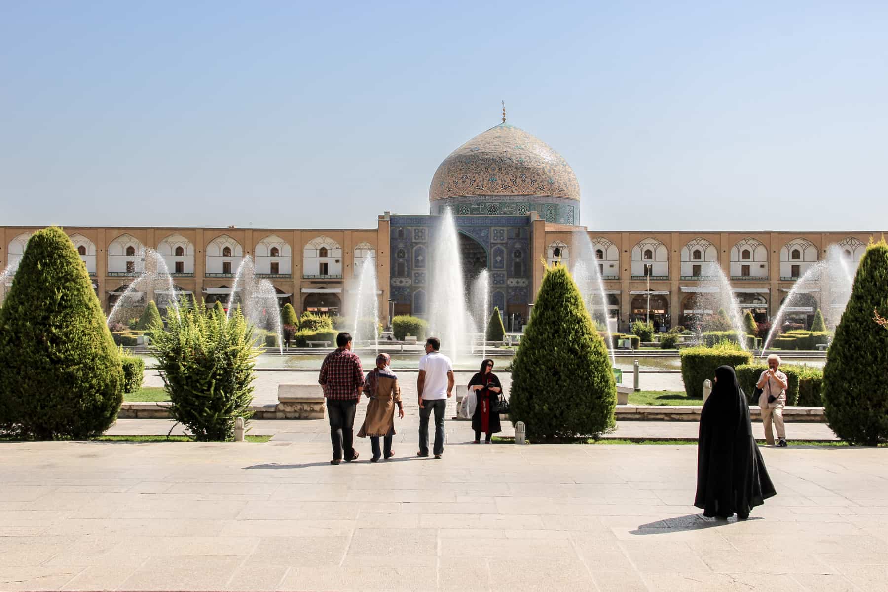 Visitors walking in the garden grounds in front of The Great Mosque Masjid-e Jameh of Isfahan on an Iran trip. 