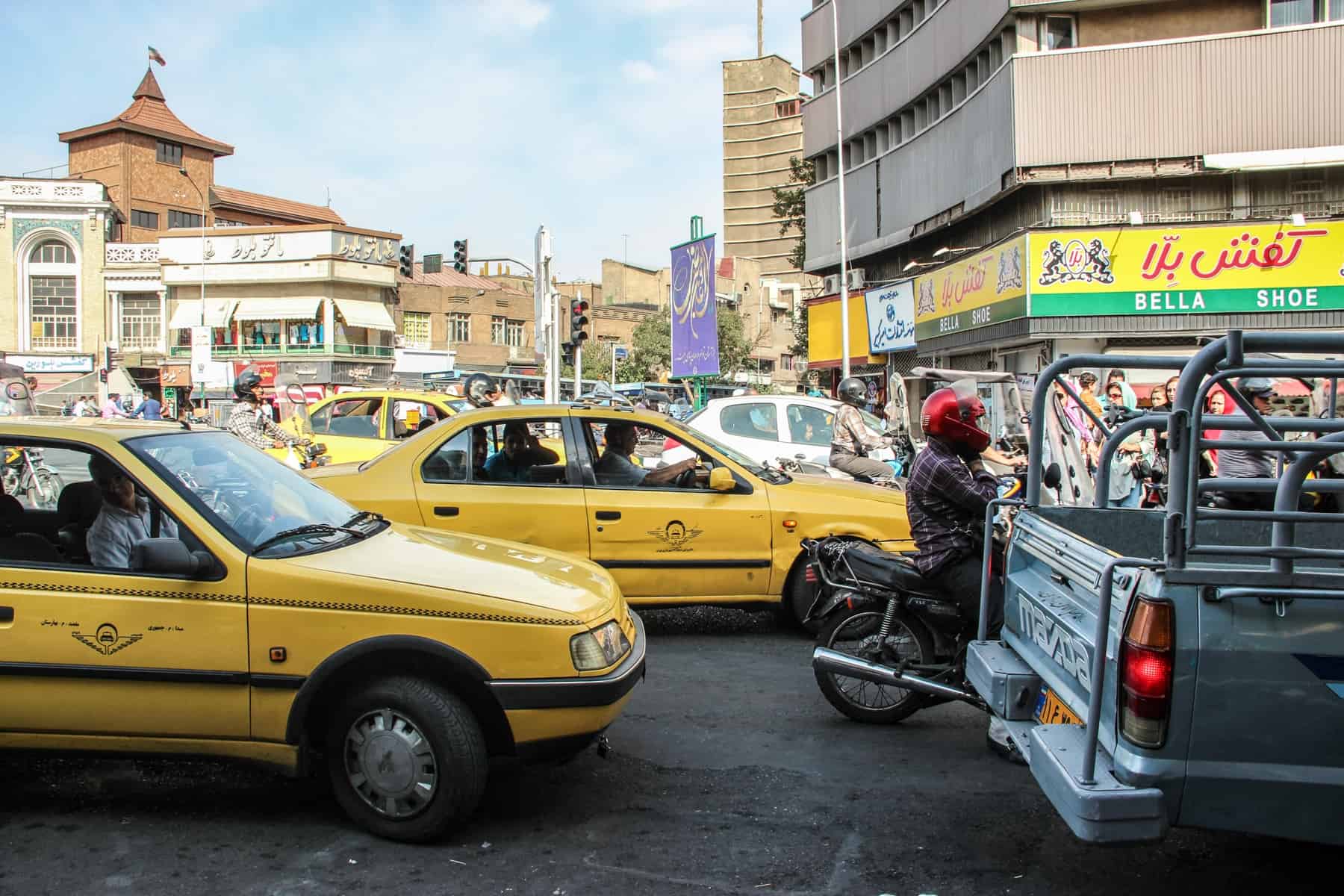 Iranian Yellow taxis in Tehran in heavy traffic in the centre of the city. 