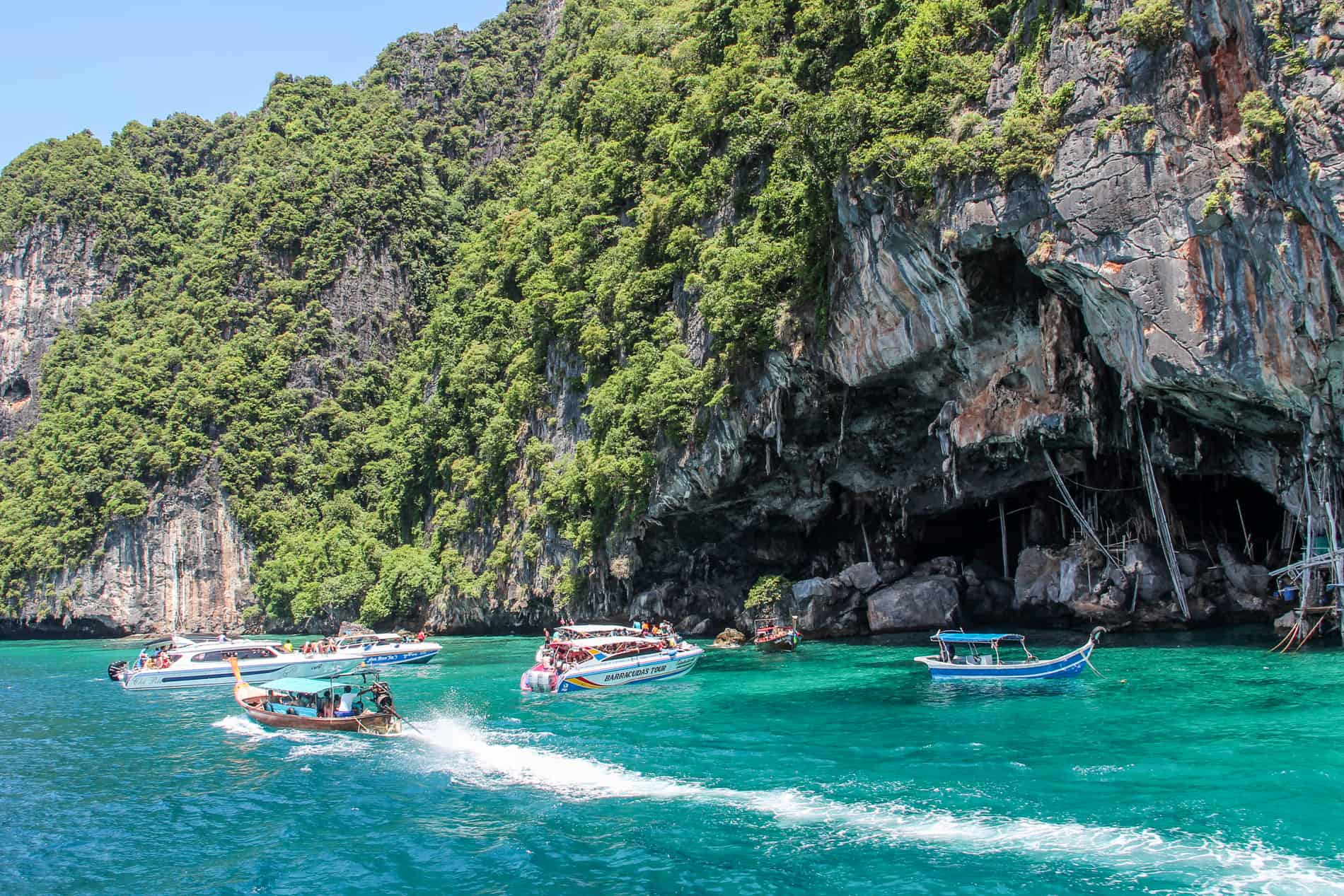 Tourists boats on the emerald waters of Koh Phi Phi Leh Island
