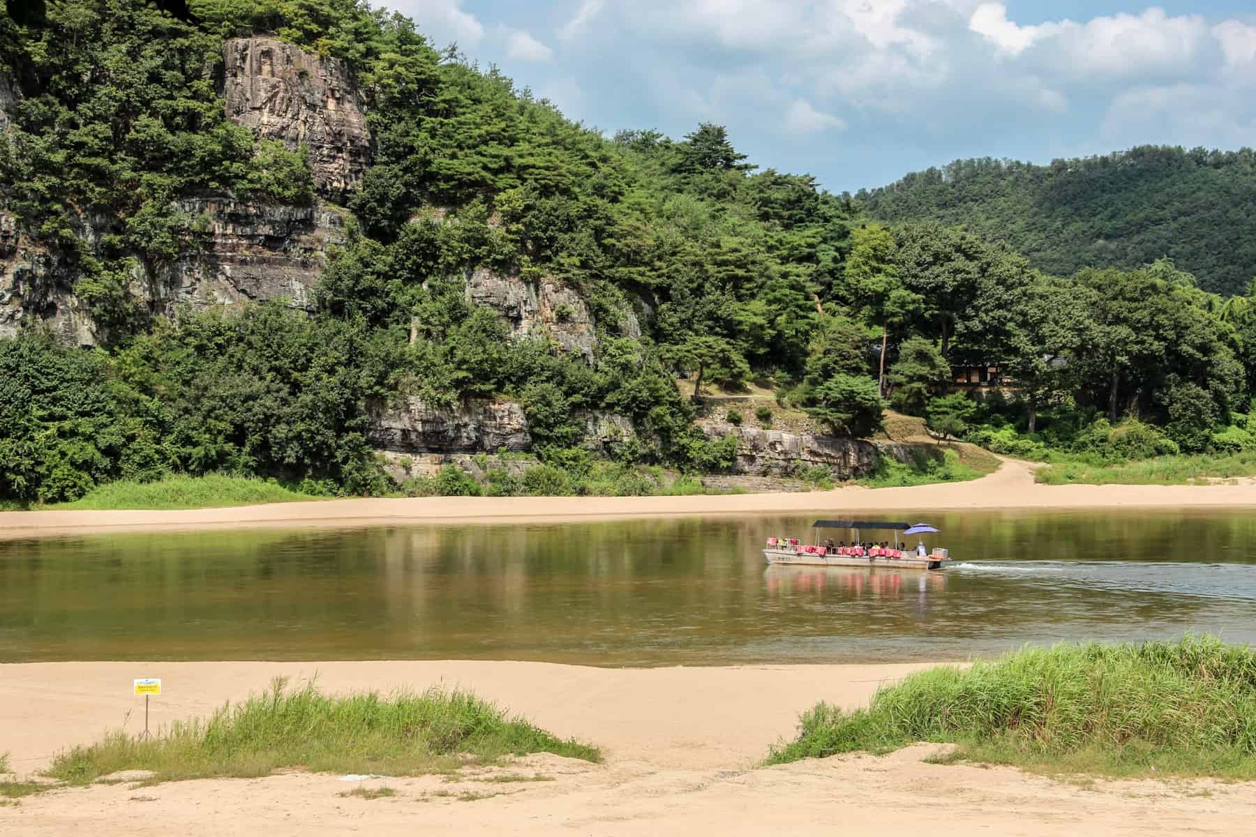 Tourists on a boat trip in a dense forest area in South Korea. 