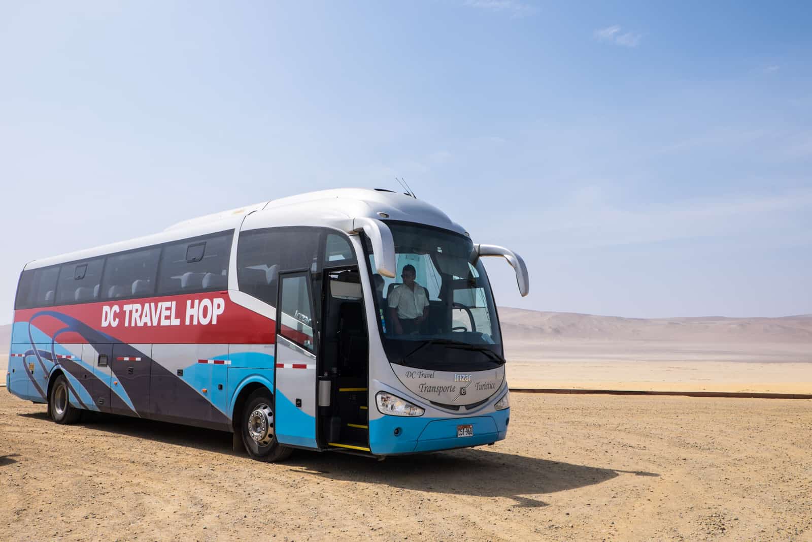 The Peru Hop tourist bus in the Paracas National reserve desert. 