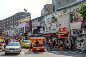 A busy street in a Seoul neighbourhood lined with funky outlets and boutique stores.