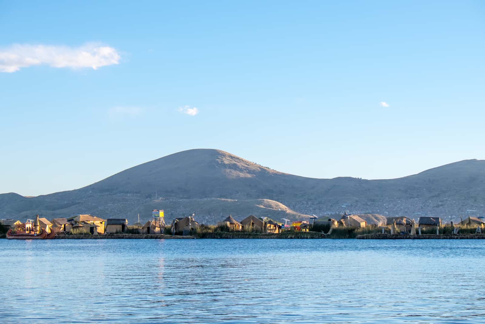 A row of reed houses on a floating island in Lake Titicaca in Puno. 