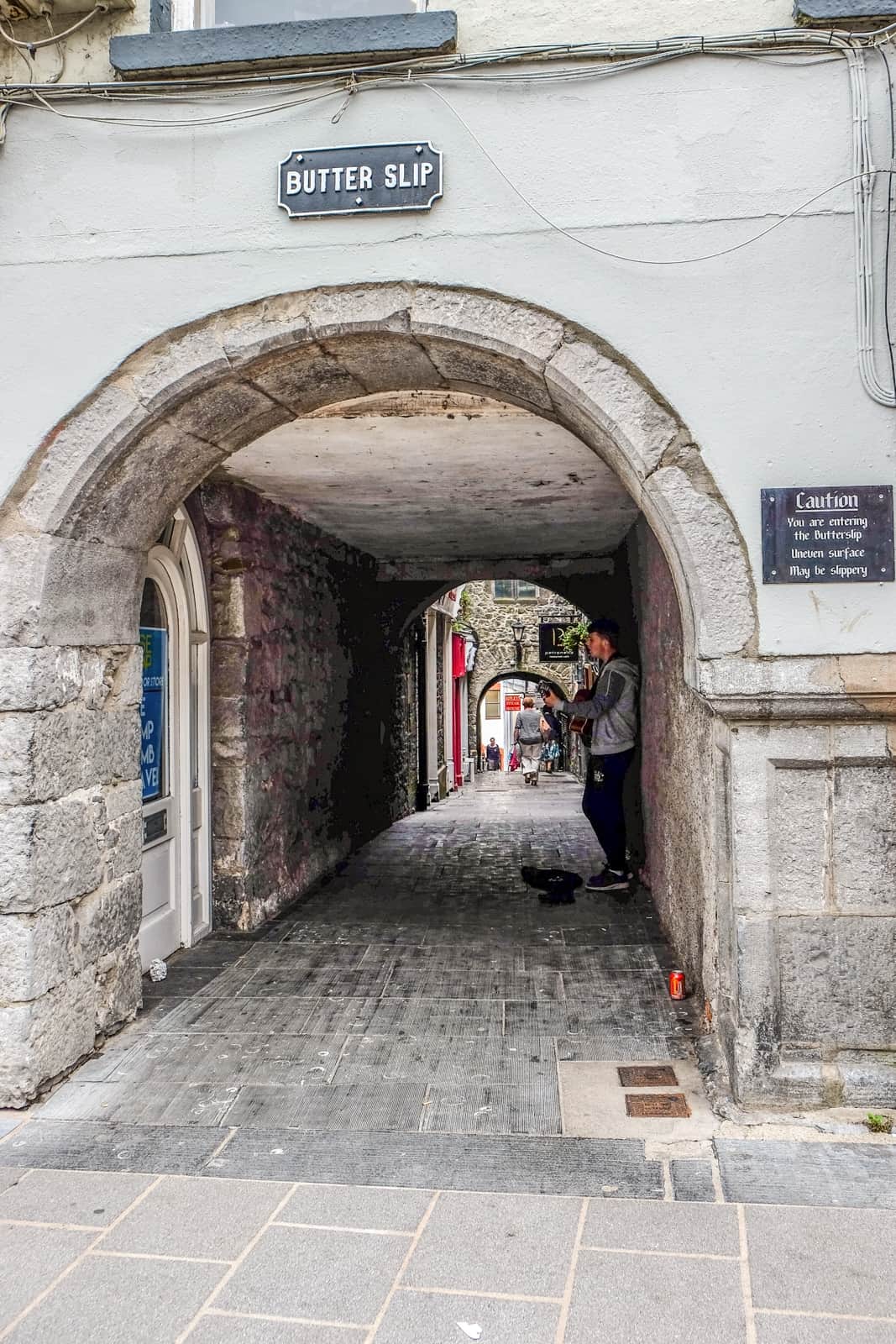 A man playing music in the medieval Butterslip Lane in Kilkenny. 